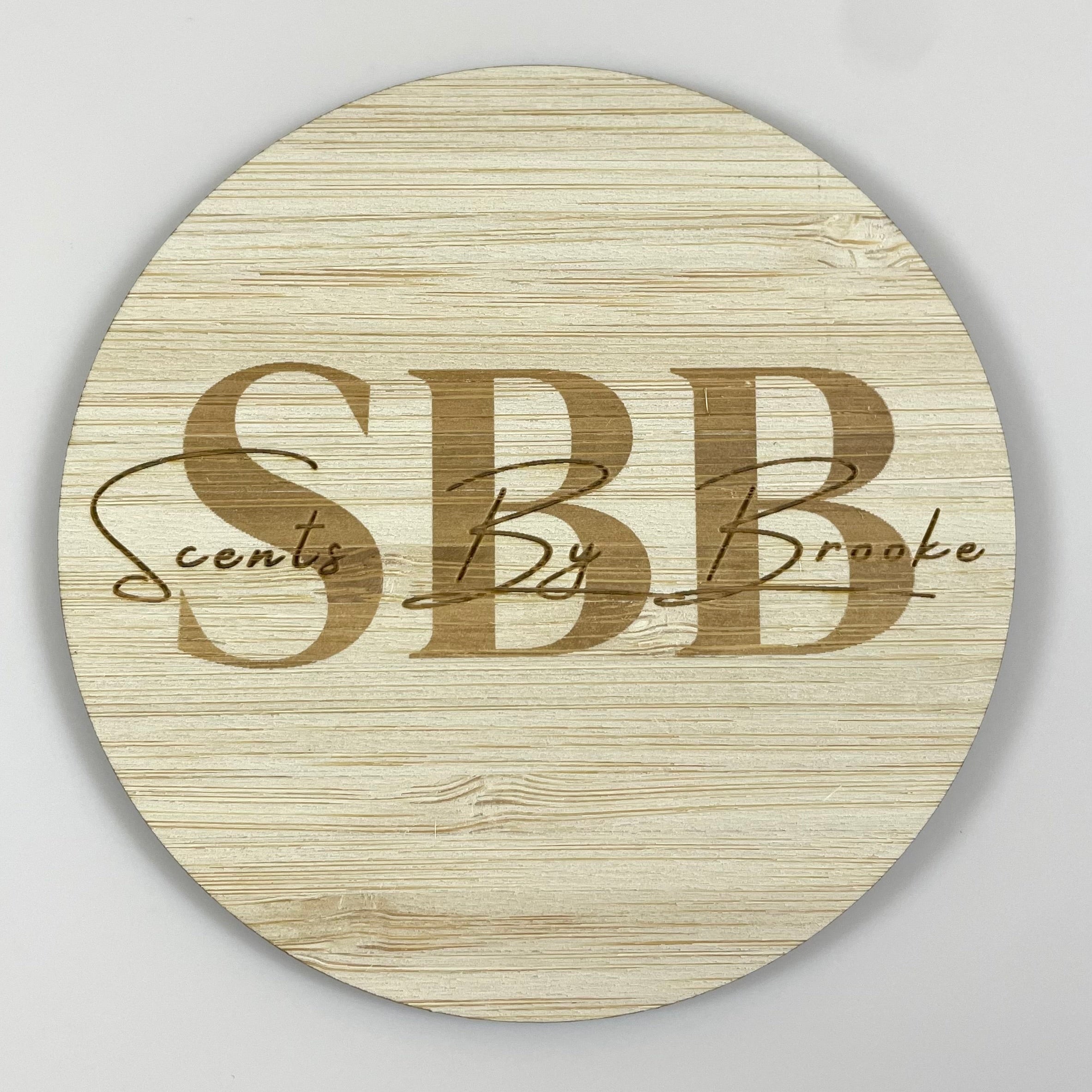 Custom bamboo logo disc engraved with business initials – perfect for flat lay branding