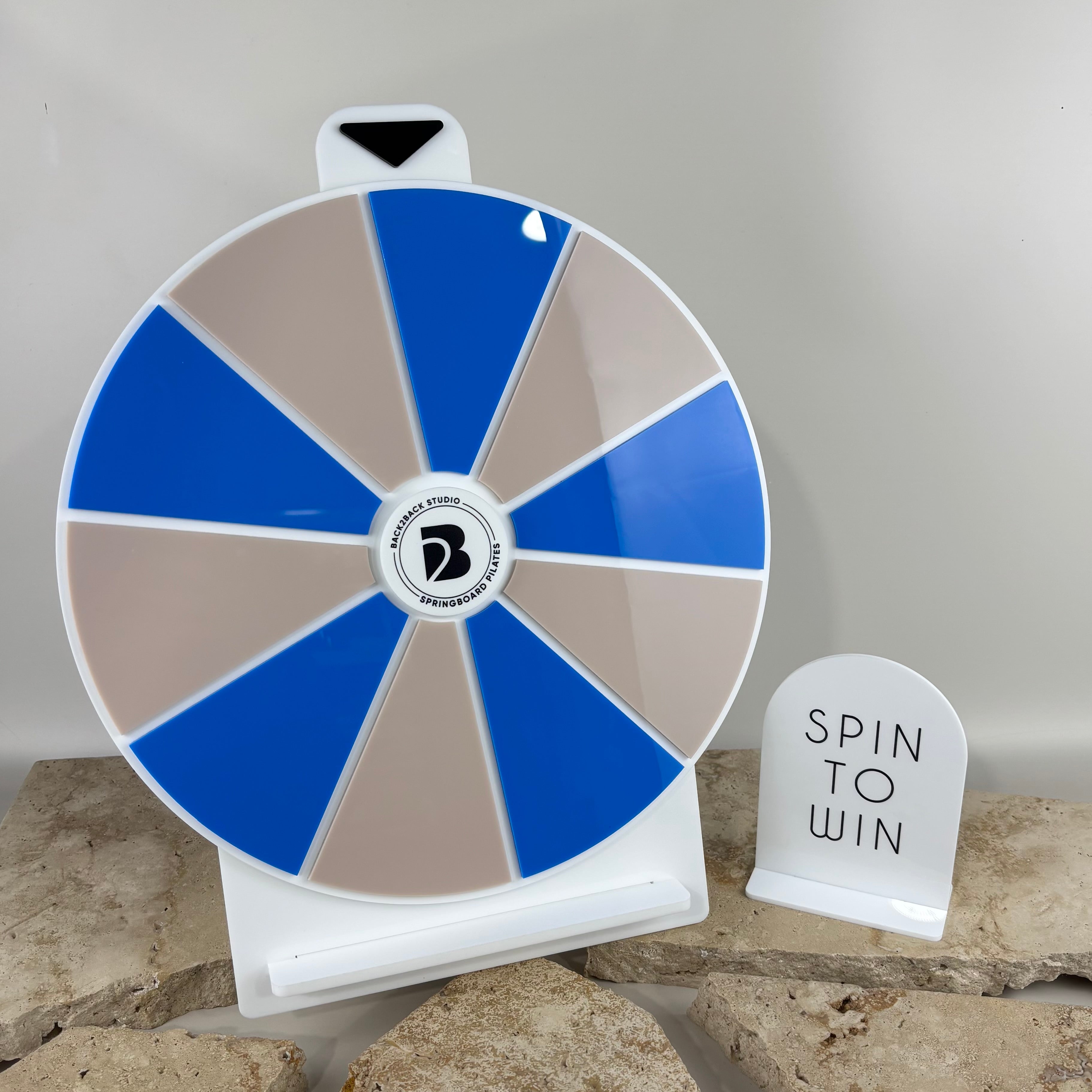 Custom acrylic spin the wheel for businesses and events, branded prize wheel display for salons, retail stores and market stalls, personalised spin to win competition wheel for customer engagement, promotional business giveaway stand