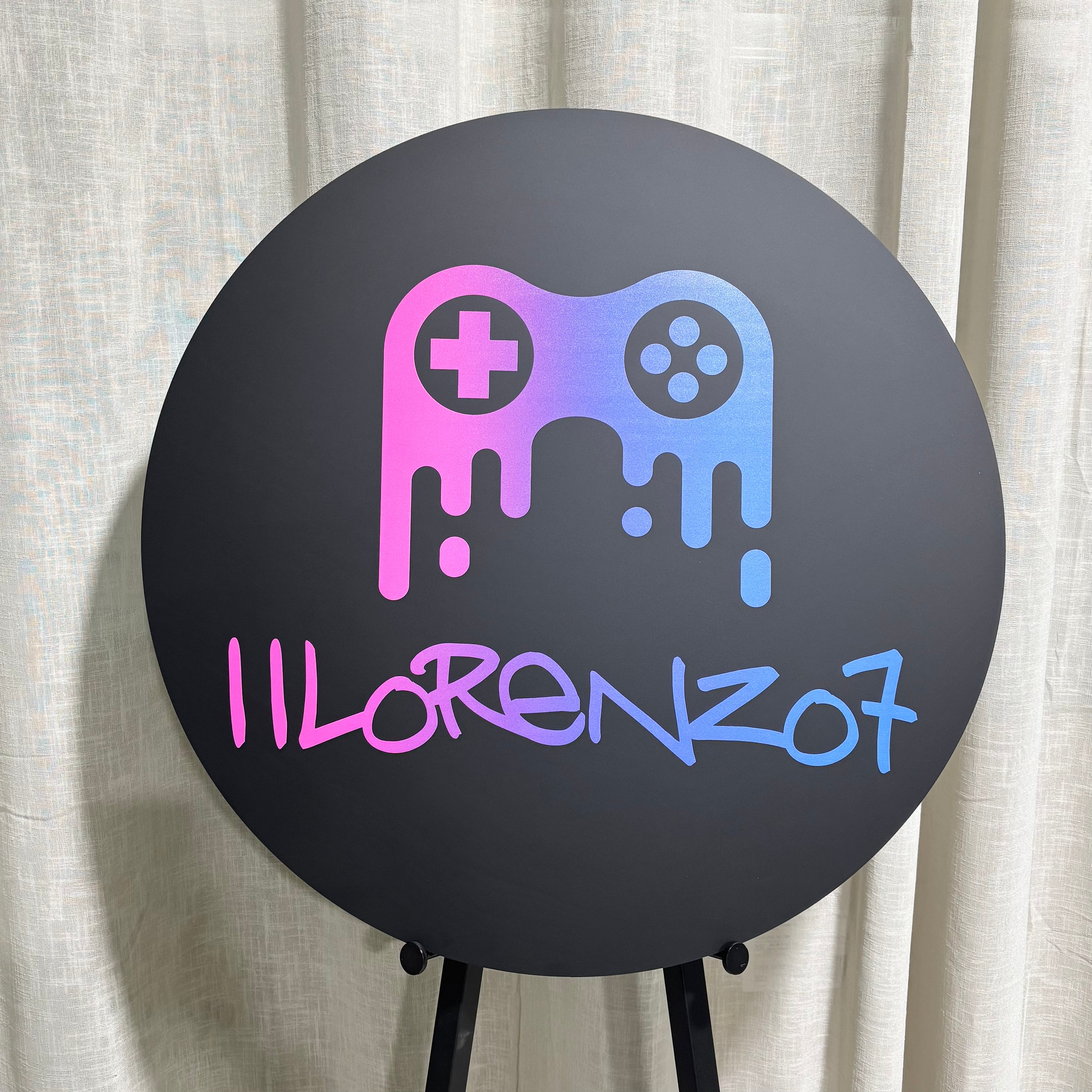 Custom UV printed round acrylic business sign featuring a colourful gaming controller logo and personalised branding. Professional UV printed signage for gaming rooms, streamers, esports businesses, gaming stores and entertainment venues with vibrant full-colour print on black acrylic.