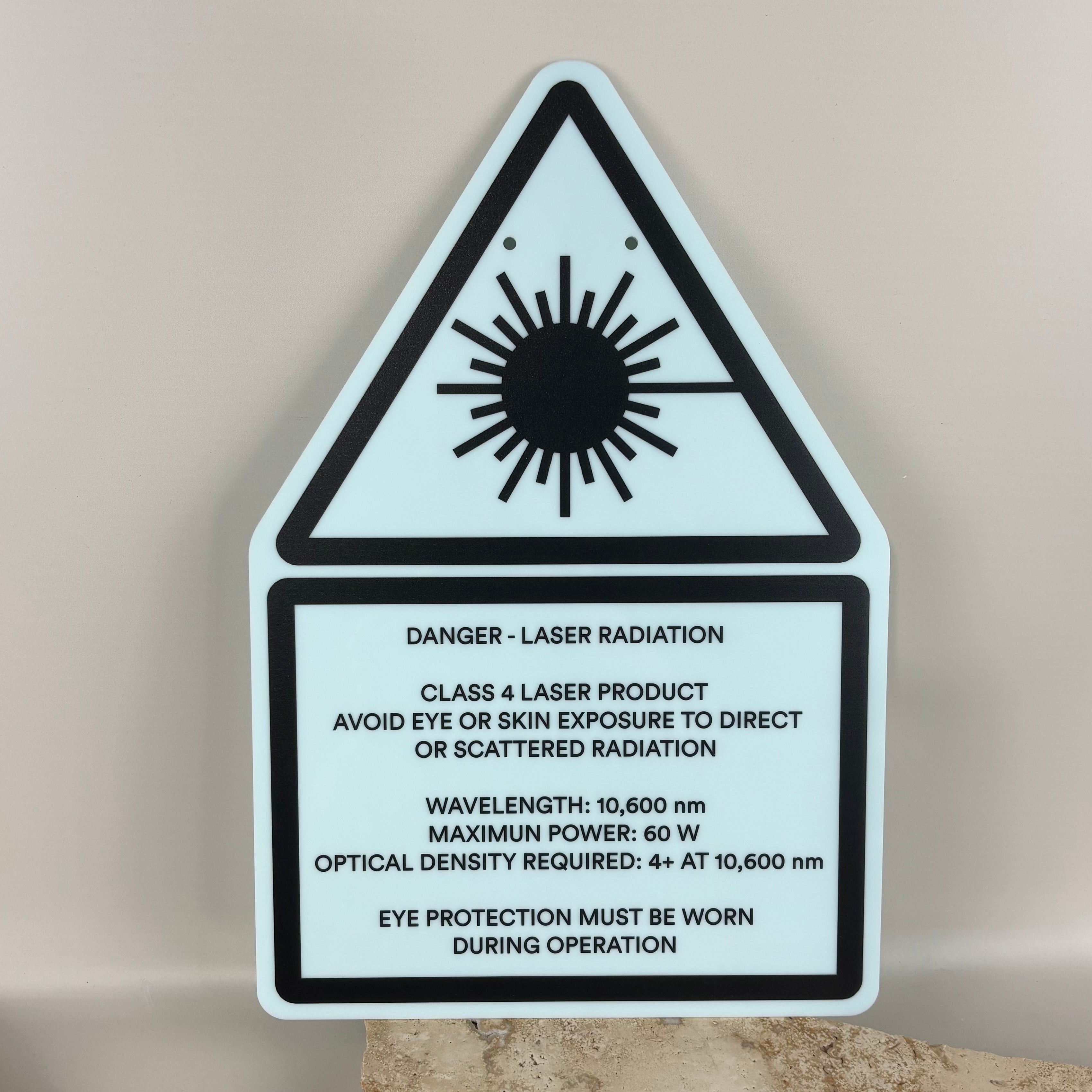 Class 4 laser radiation safety sign made from layered acrylic with laser hazard triangle symbol and warning text, professional laser safety sign for laser engraving machines and workshop environments.