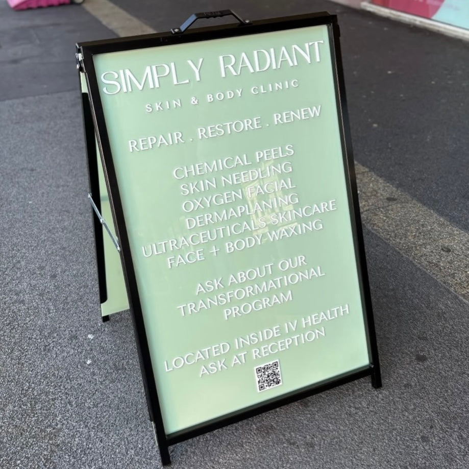 Custom A-frame business sign with raised 3D acrylic lettering for a skin and body clinic, featuring a soft green panel and white text, designed for outdoor shopfront advertising to attract foot traffic.