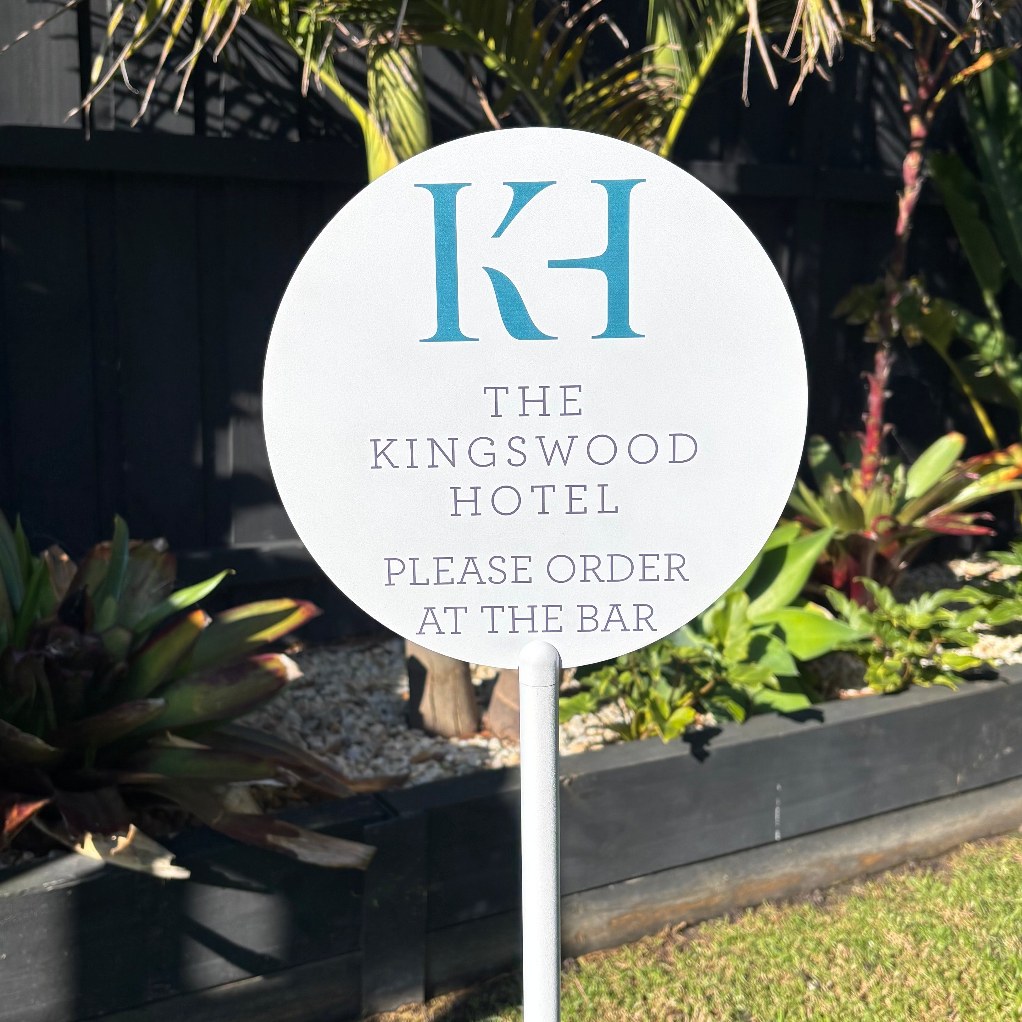 Custom round outdoor order at the bar sign with white powder coated post, UV printed branding and weather-resistant finish for hotels, pubs, clubs, restaurants, cafés, beer gardens and hospitality venues.