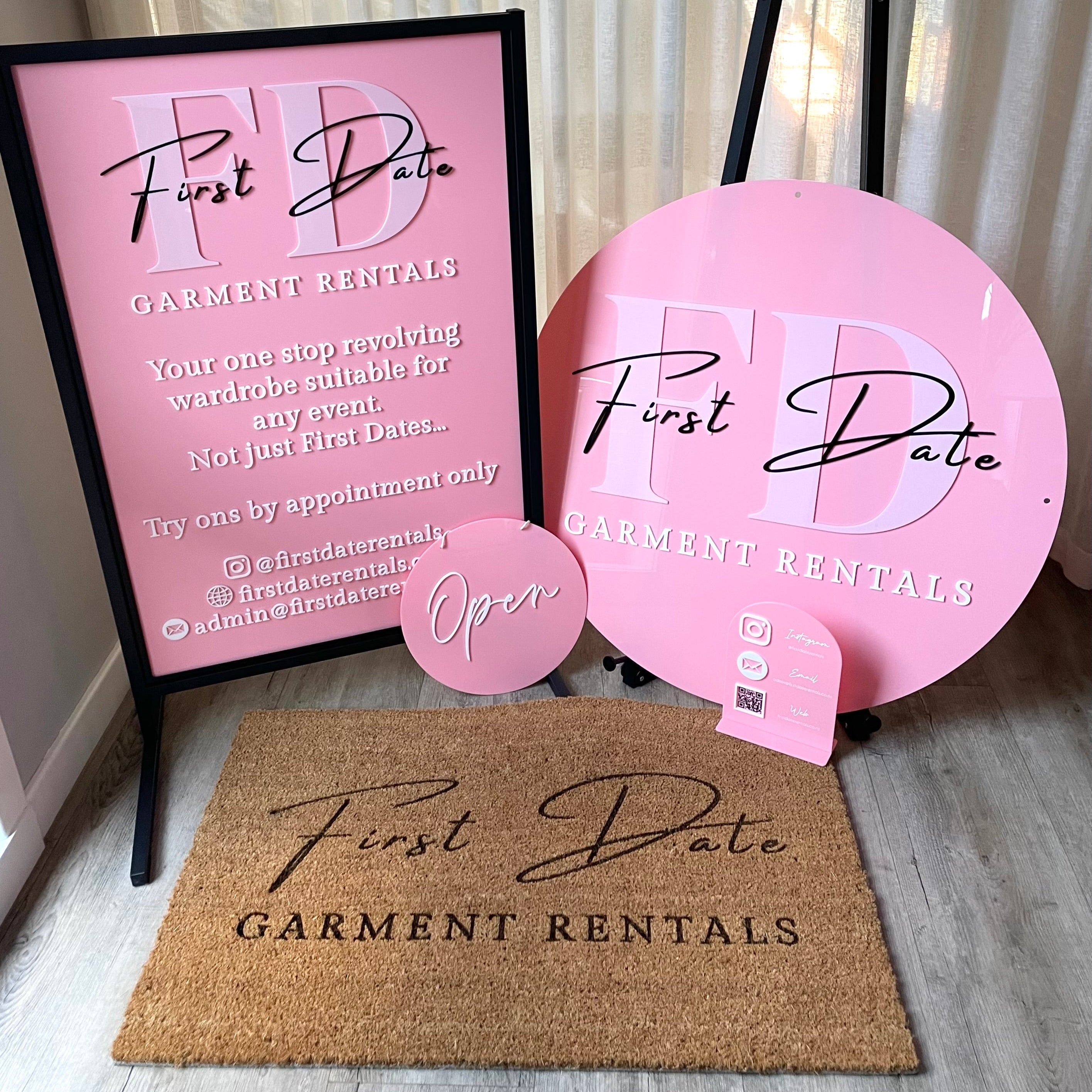 Pink beauty salon signage bundle for First Date Brows featuring round logo sign, T frame and floor mat