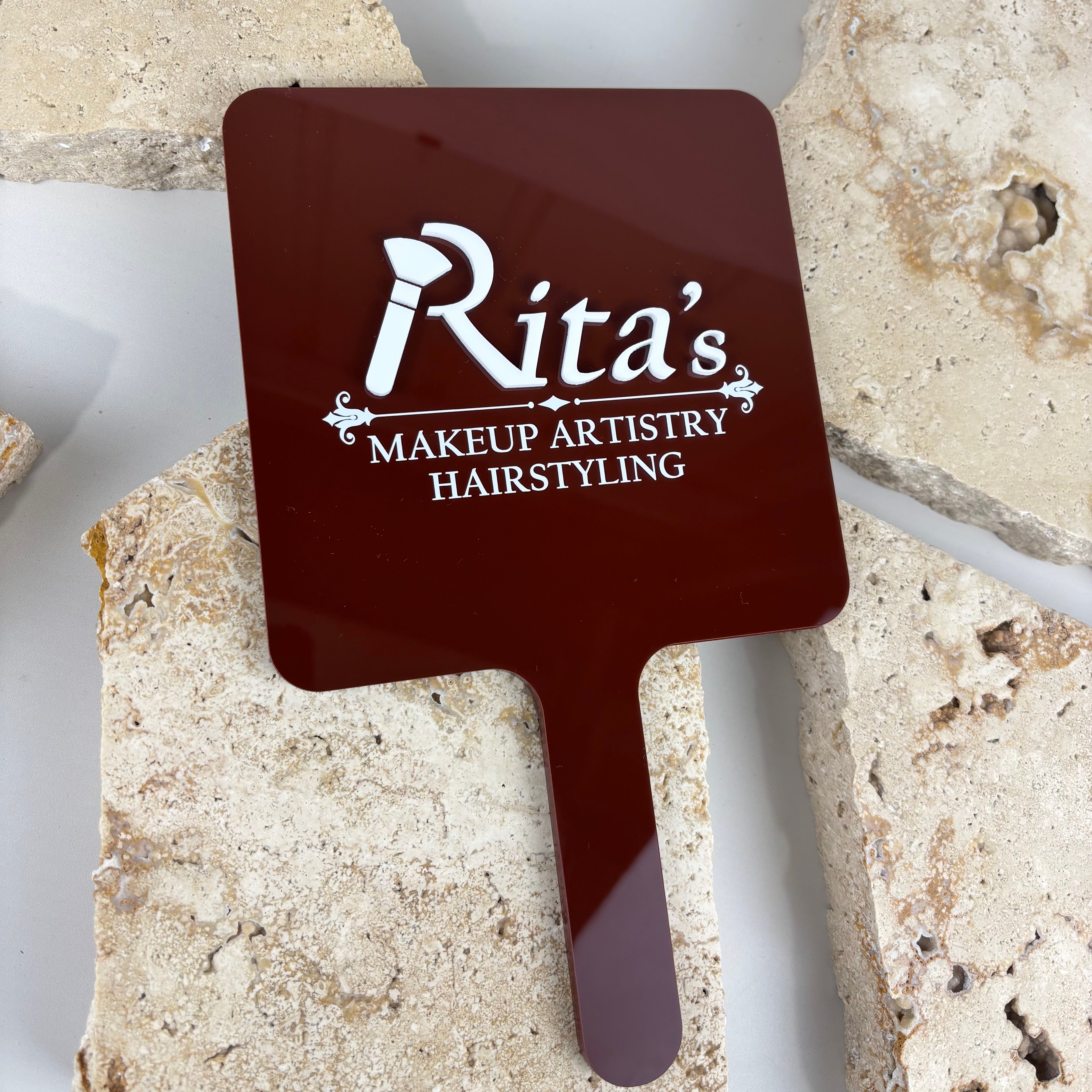 Custom handheld mirror with raised acrylic logo, glossy deep red salon mirror featuring white 3D lettering, personalised hairdresser mirror for client reveals, branded beauty mirror for makeup artists and hairstylists, acrylic mirror Australia-made