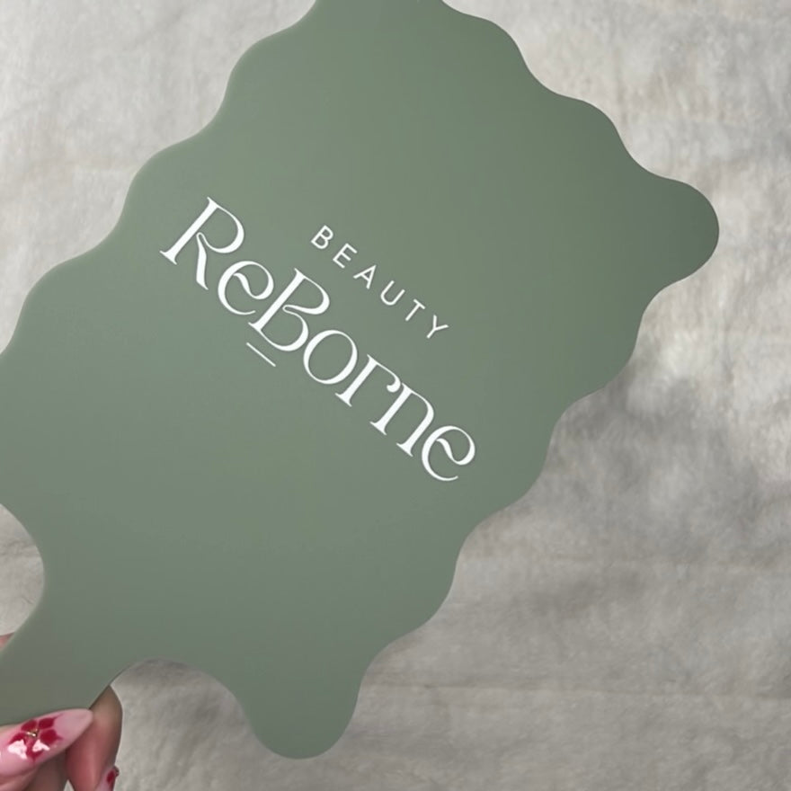 Custom acrylic scalloped handheld mirror in sage green with white logo, branded beauty salon mirror for client photos, treatment reveals and professional salon setup Australia