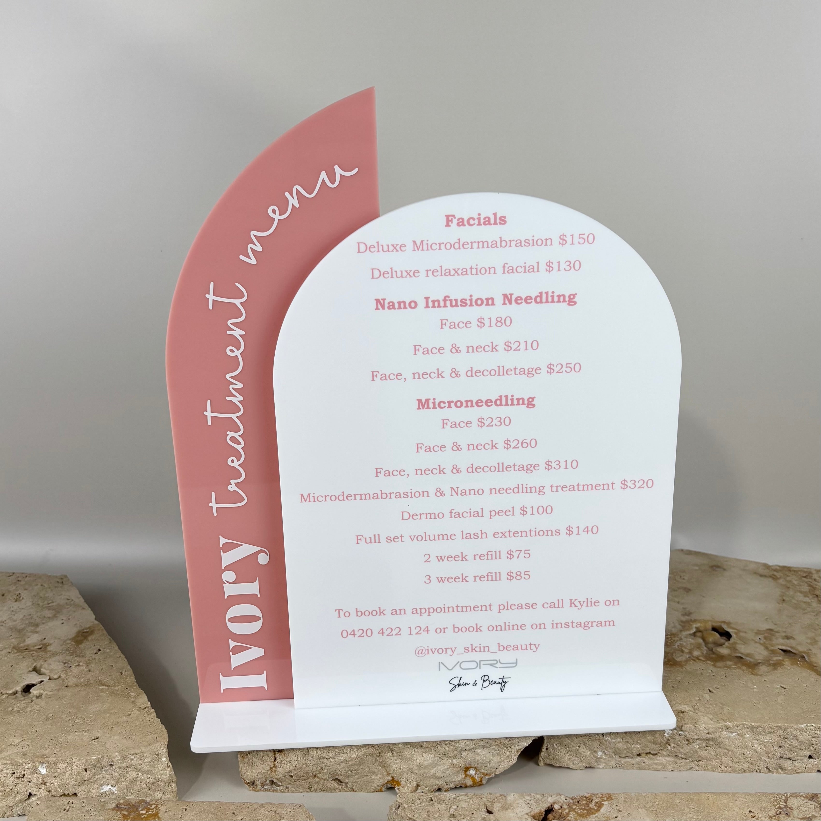 Custom acrylic treatment menu sign on arch display stand for beauty salon reception counter