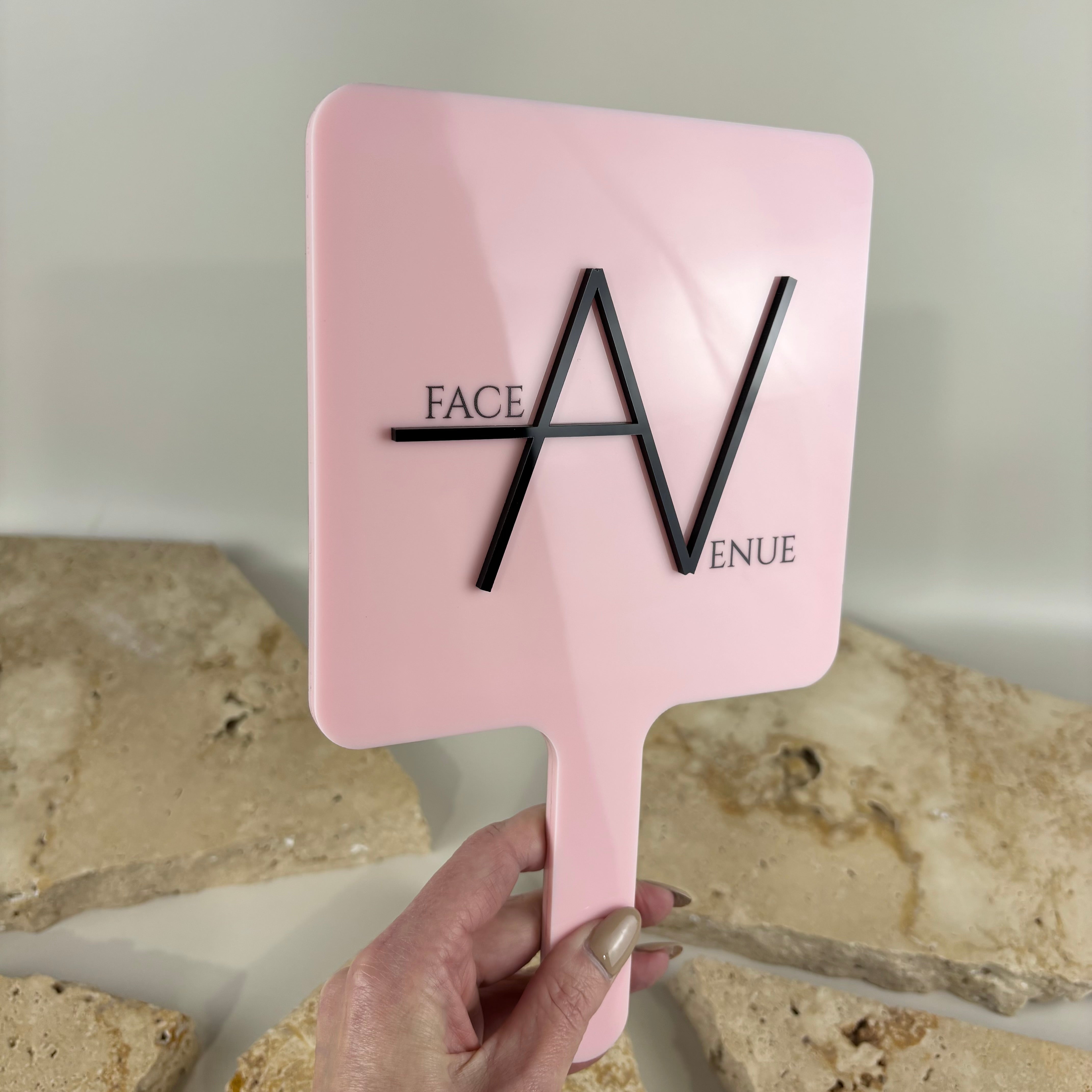 Custom pink handheld salon mirror with raised 3D acrylic logo branding for beauty salons, hairdressers and makeup artists. Personalised acrylic hand mirror designed for client reveal photos, salon styling stations, social media content and professional beauty business branding in Australia.