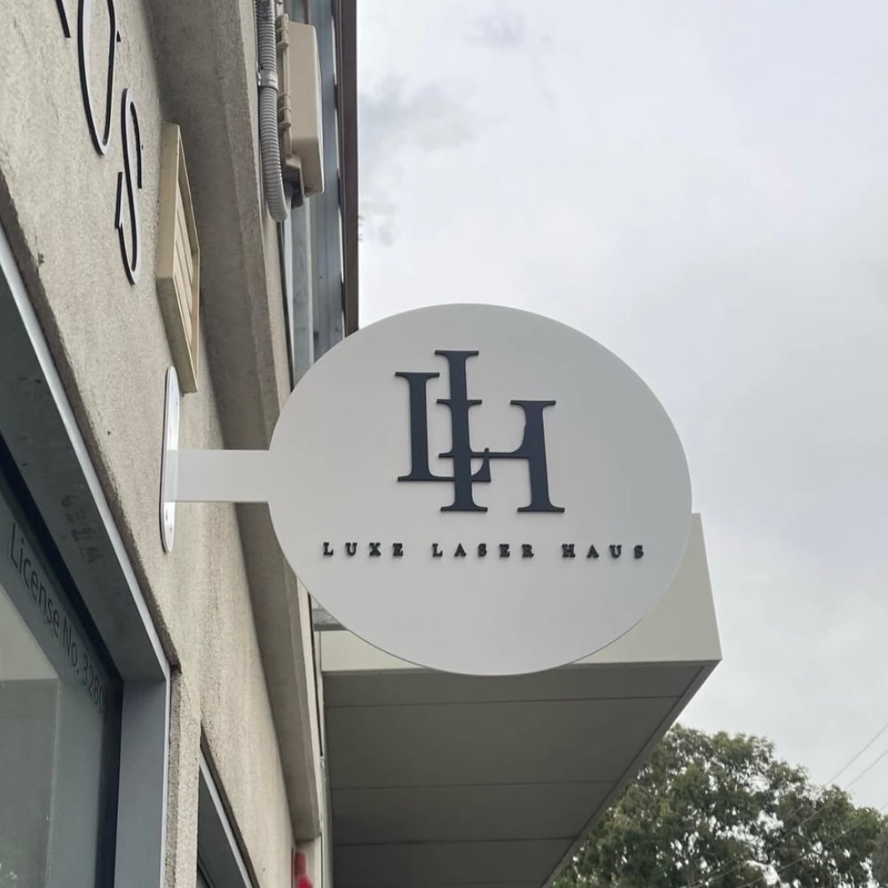 Custom round acrylic blade sign with 3D lettering mounted on building exterior, modern business signage for salons, clinics and shopfronts Australia