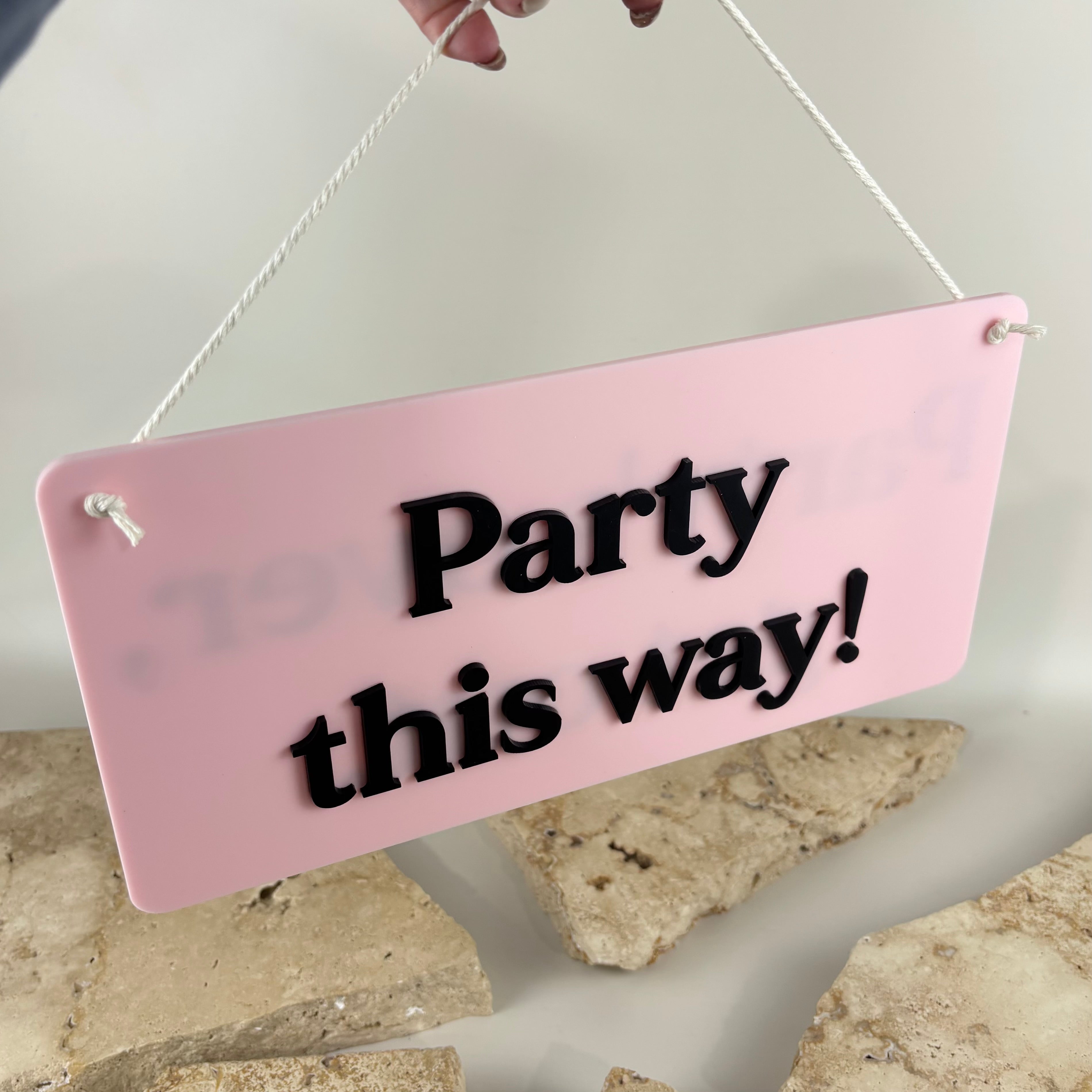 Custom acrylic party this way sign with 3D black lettering, pink directional party sign, hanging acrylic event sign, birthday party wayfinding sign, bridal shower decor, hens party signage, wedding reception direction sign, custom celebration signage, acrylic arrow alternative sign, modern party decoration, personalised event sign, pink acrylic wall hanging, reusable party decor Australia.