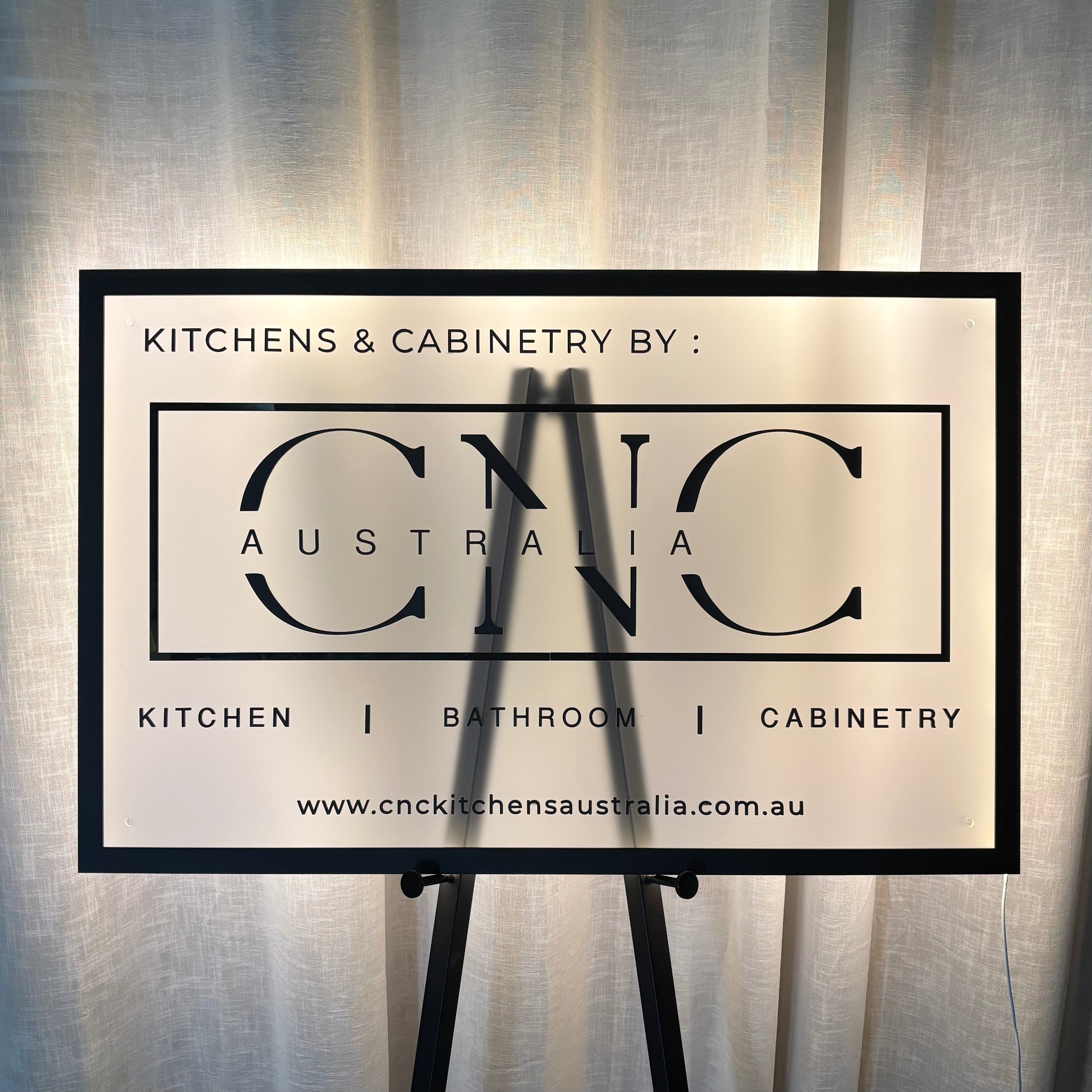 Custom 3D backlit acrylic business sign with illuminated LED halo lighting, premium CNC cabinetry logo sign, custom reception and showroom signage, modern illuminated business branding display, kitchen and bathroom cabinetry company sign, Australian made LED business sign.