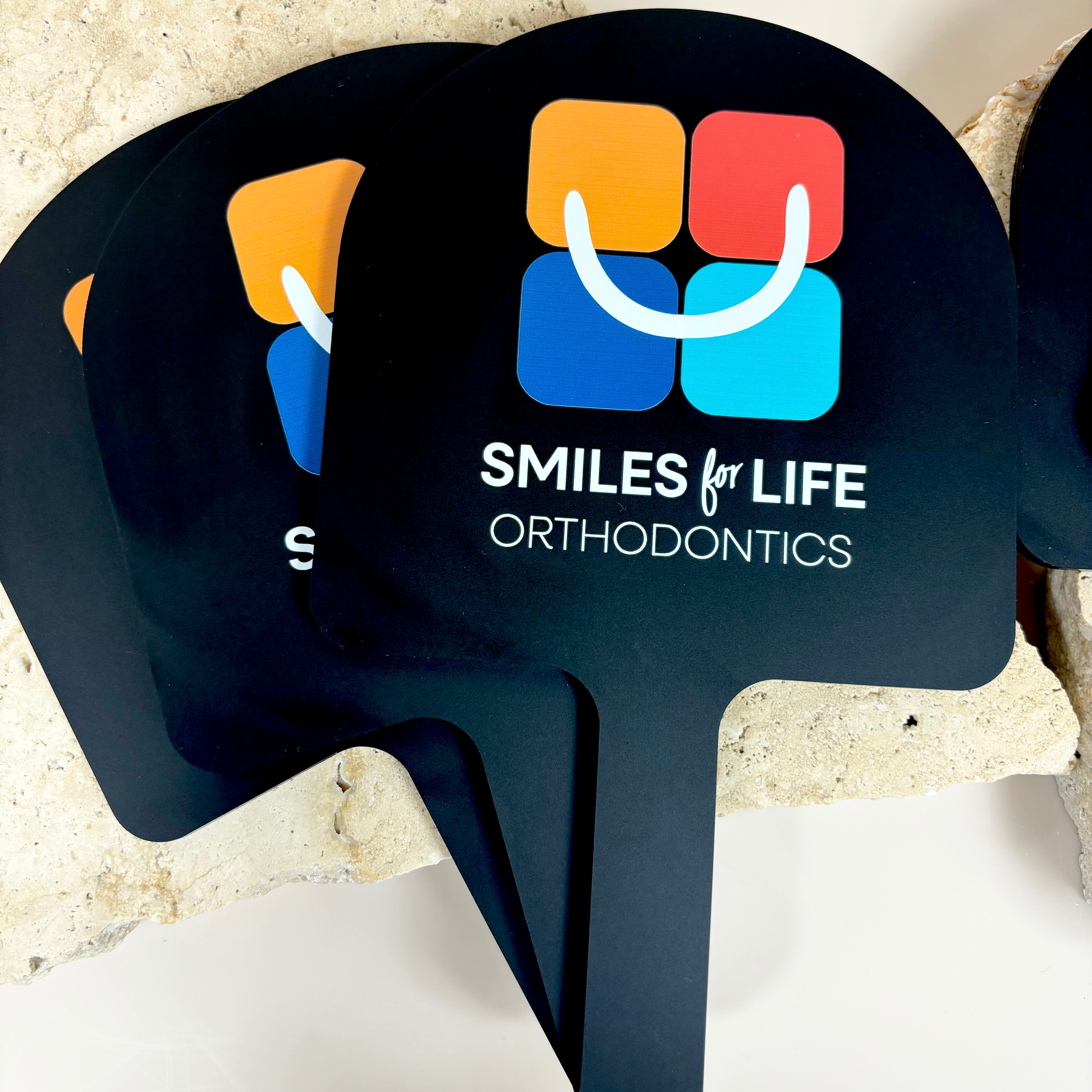 Smiles for Life Orthodontics branding on black arched mirror