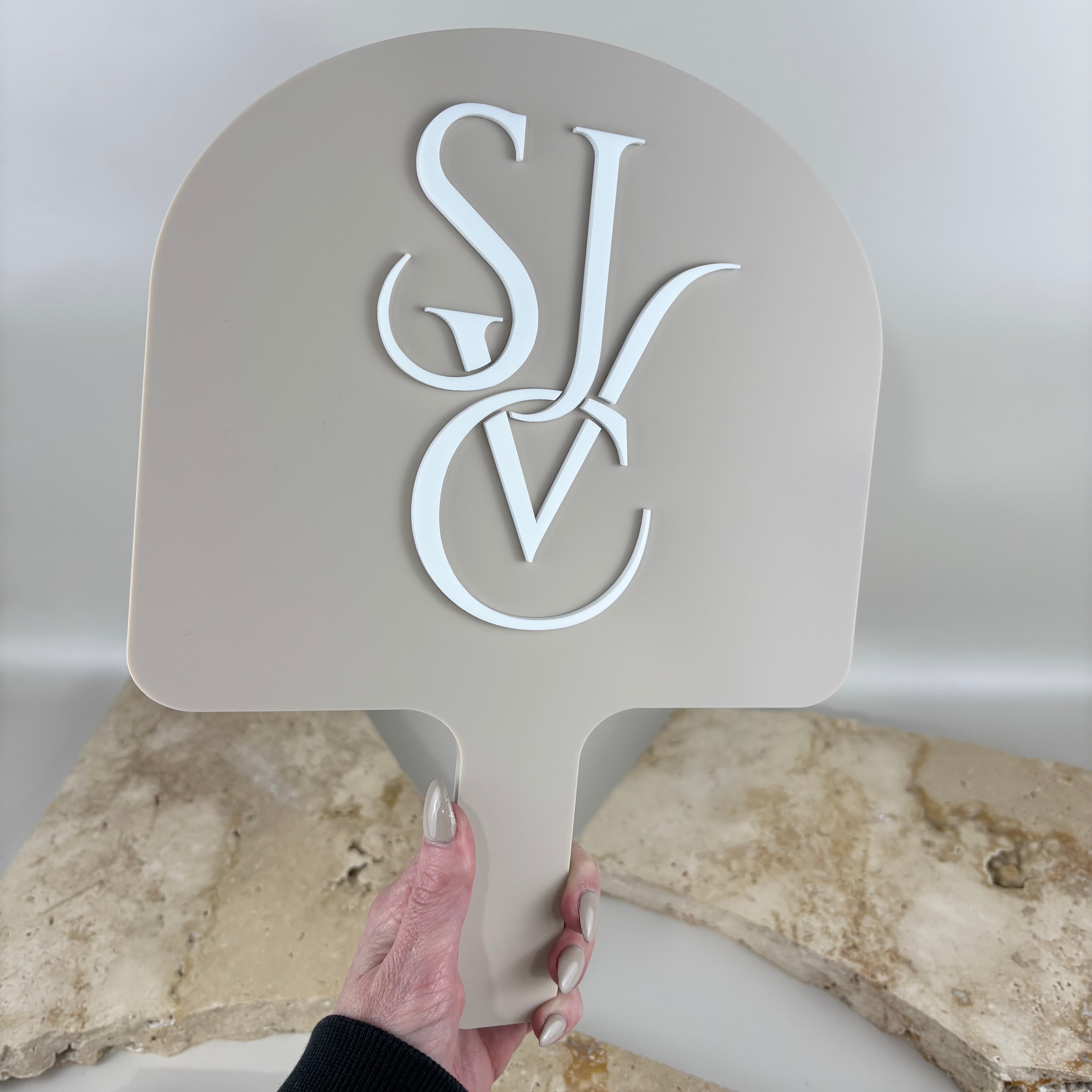 Large arch acrylic handheld salon mirror with beige back and raised white 3D business logo, custom branded for hair and beauty salons.