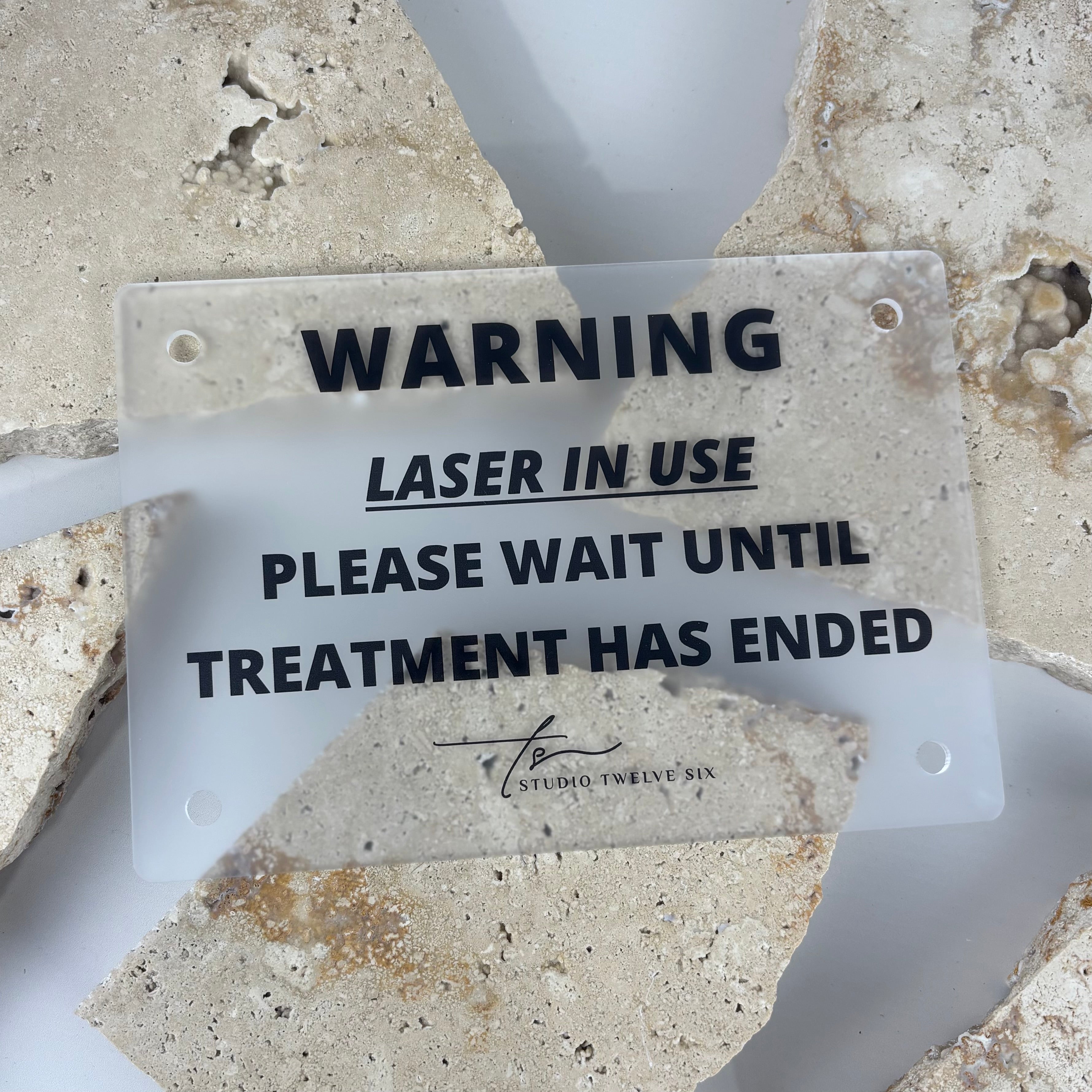 Frosted acrylic warning sign reading “Laser in Use – Please Wait Until Treatment Has Ended”, designed for laser clinics, beauty salons, and treatment rooms.