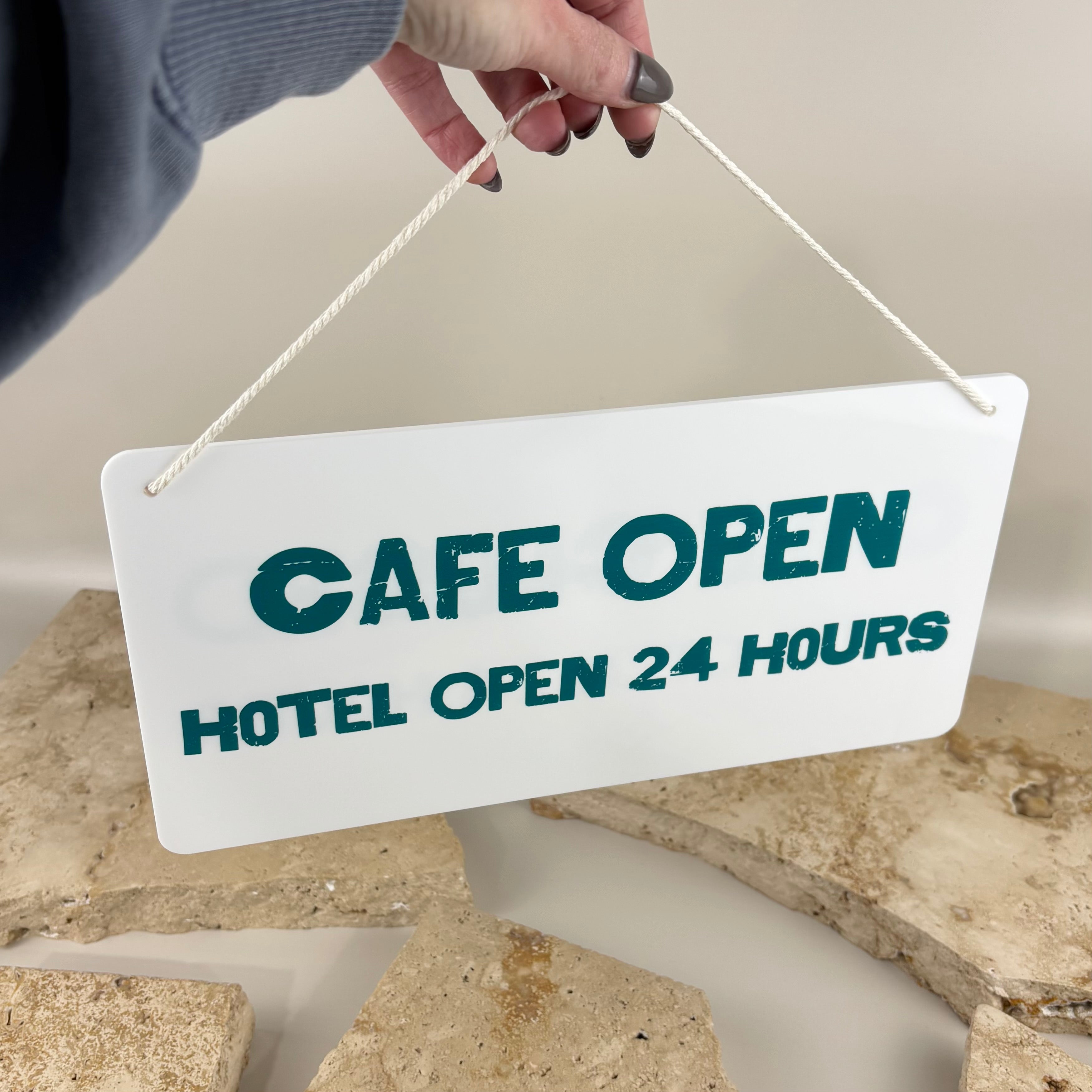 White acrylic hanging open sign with UV printed teal text and rope hanger, custom made for cafés, restaurants, hotels and retail businesses to clearly display trading status.