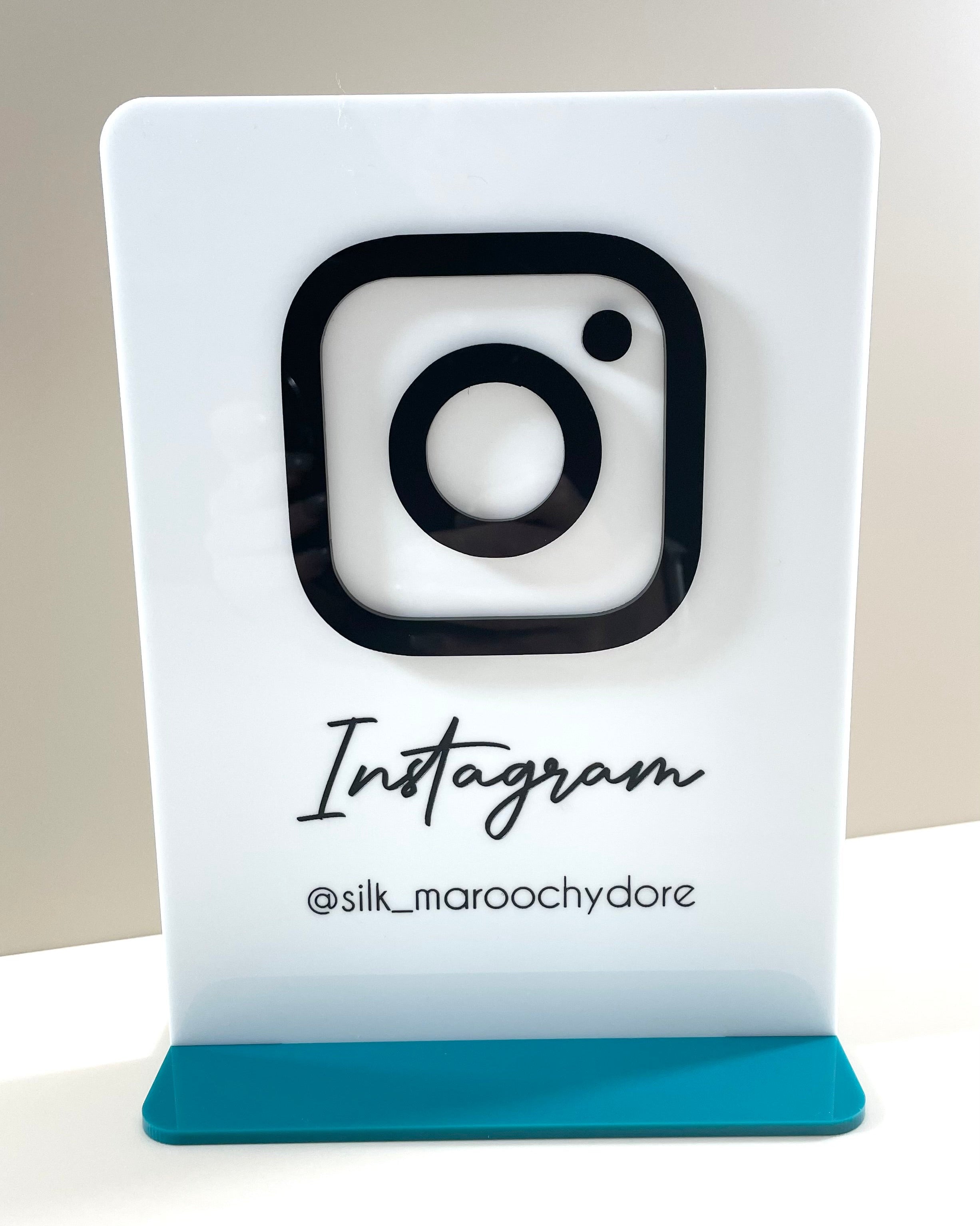 Acrylic display with bold Instagram logo for salon or market stall branding