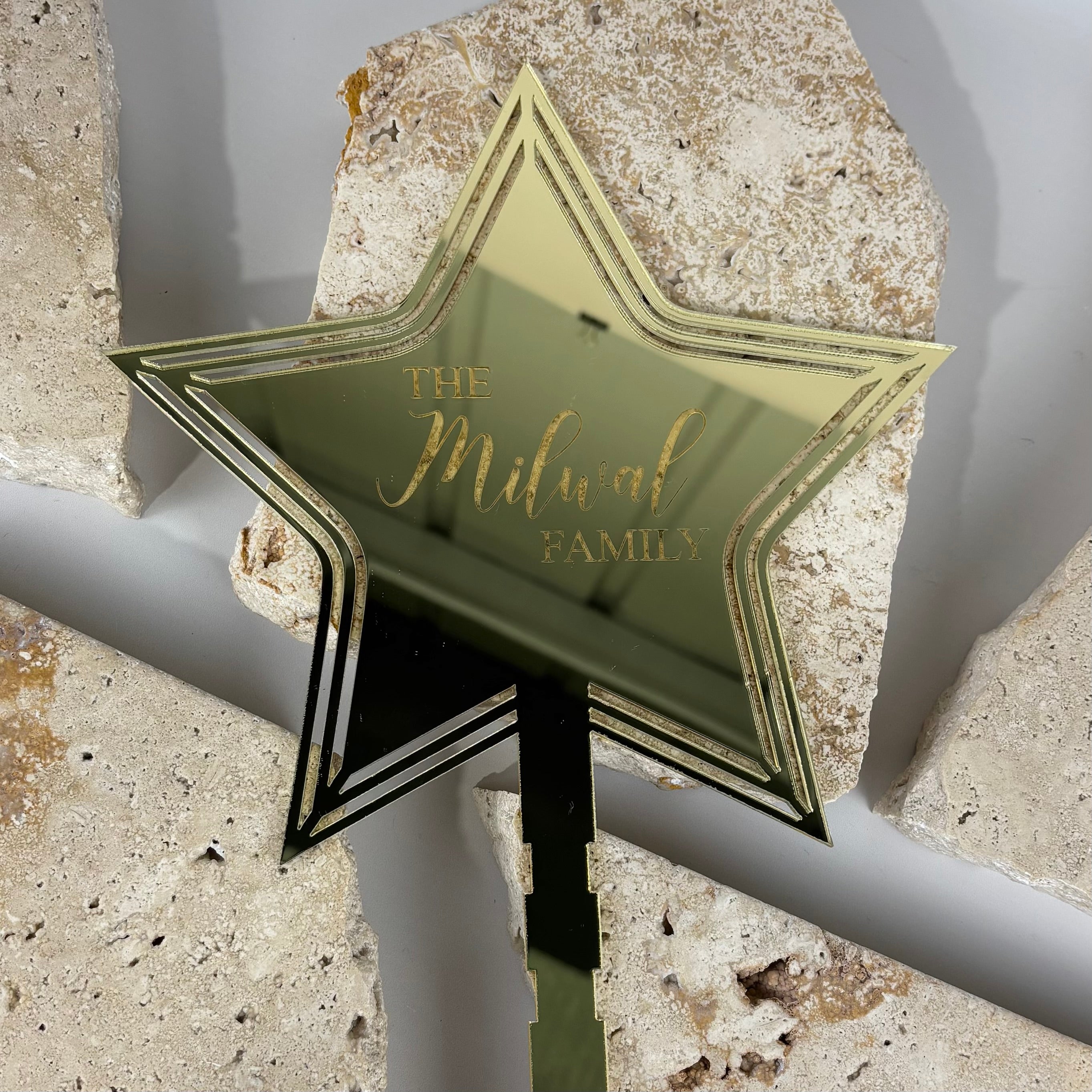 Gold mirrored acrylic star Christmas tree topper engraved with “The Milwal Family”, personalised layered star topper, luxury custom Christmas tree decoration.