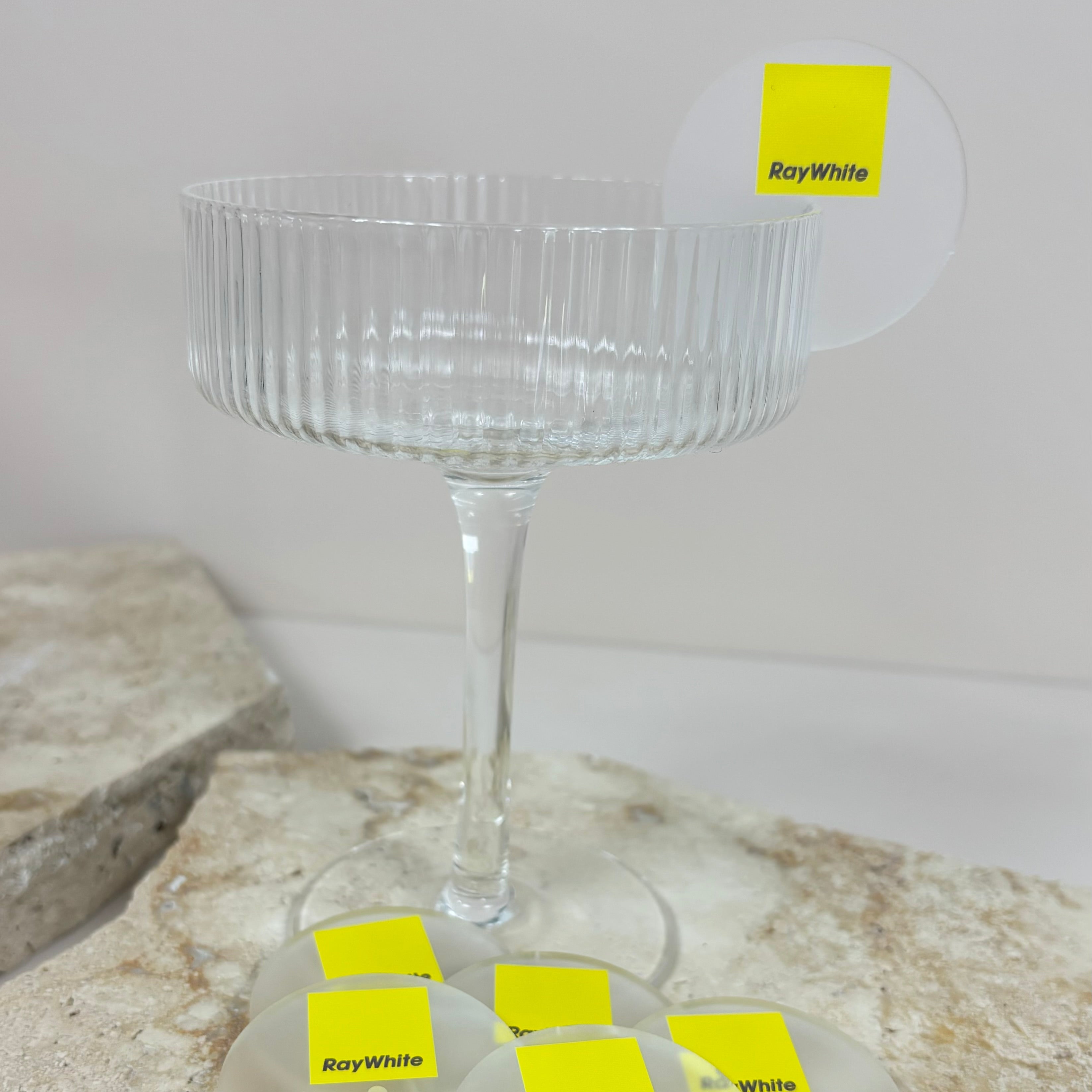 Yellow drink tags displayed on a clear glass for branding