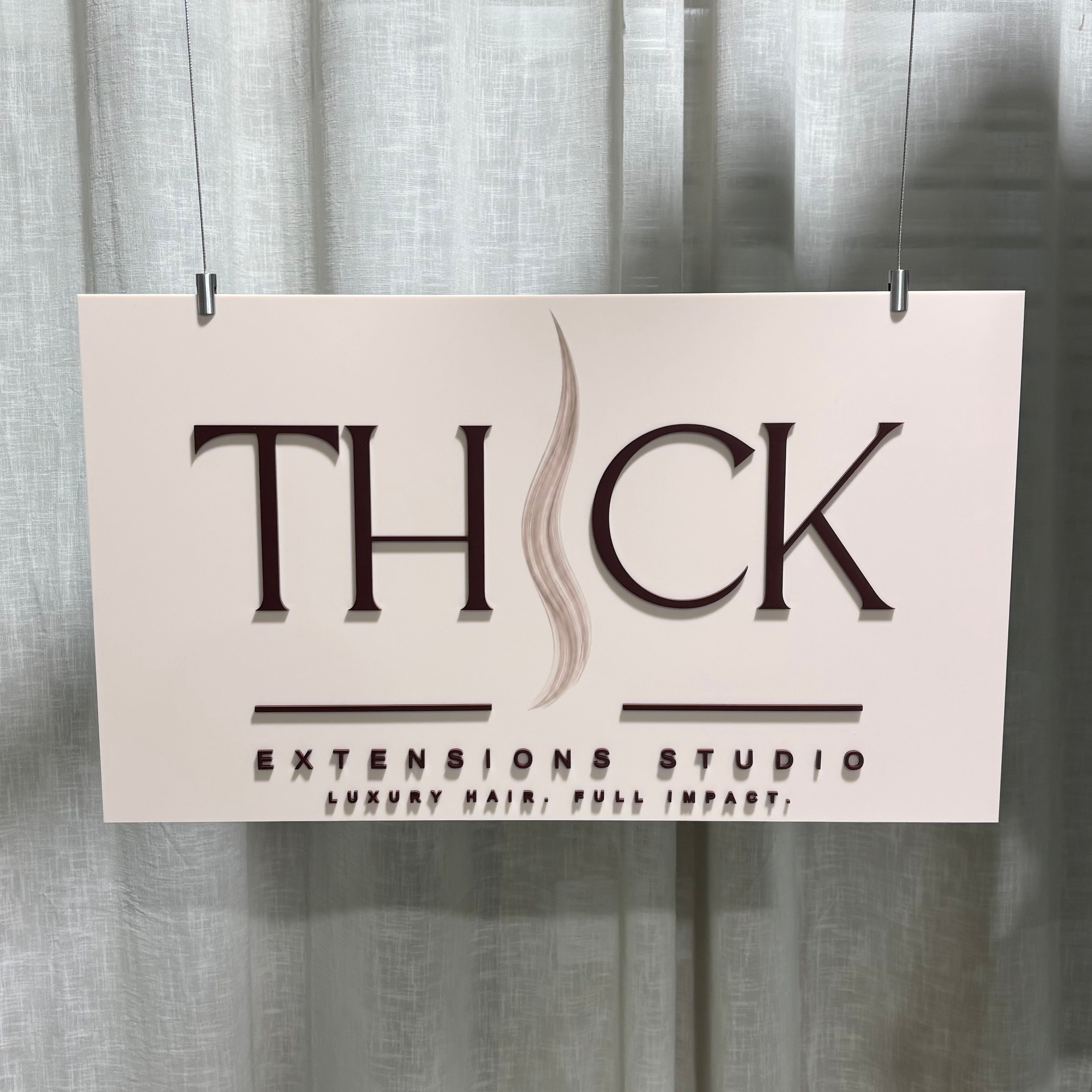 Custom suspended acrylic business sign with 3D raised lettering and logo for hair extension salons, hairdressers and beauty studios. Premium hanging reception sign featuring layered acrylic text, modern salon branding and professional interior business signage for luxury hair extension businesses.