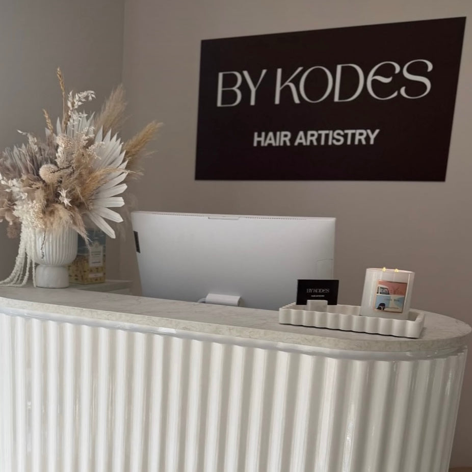 Custom 3D acrylic business sign installed in hair salon reception, acrylic lettering wall signage Australia, salon branding behind front desk