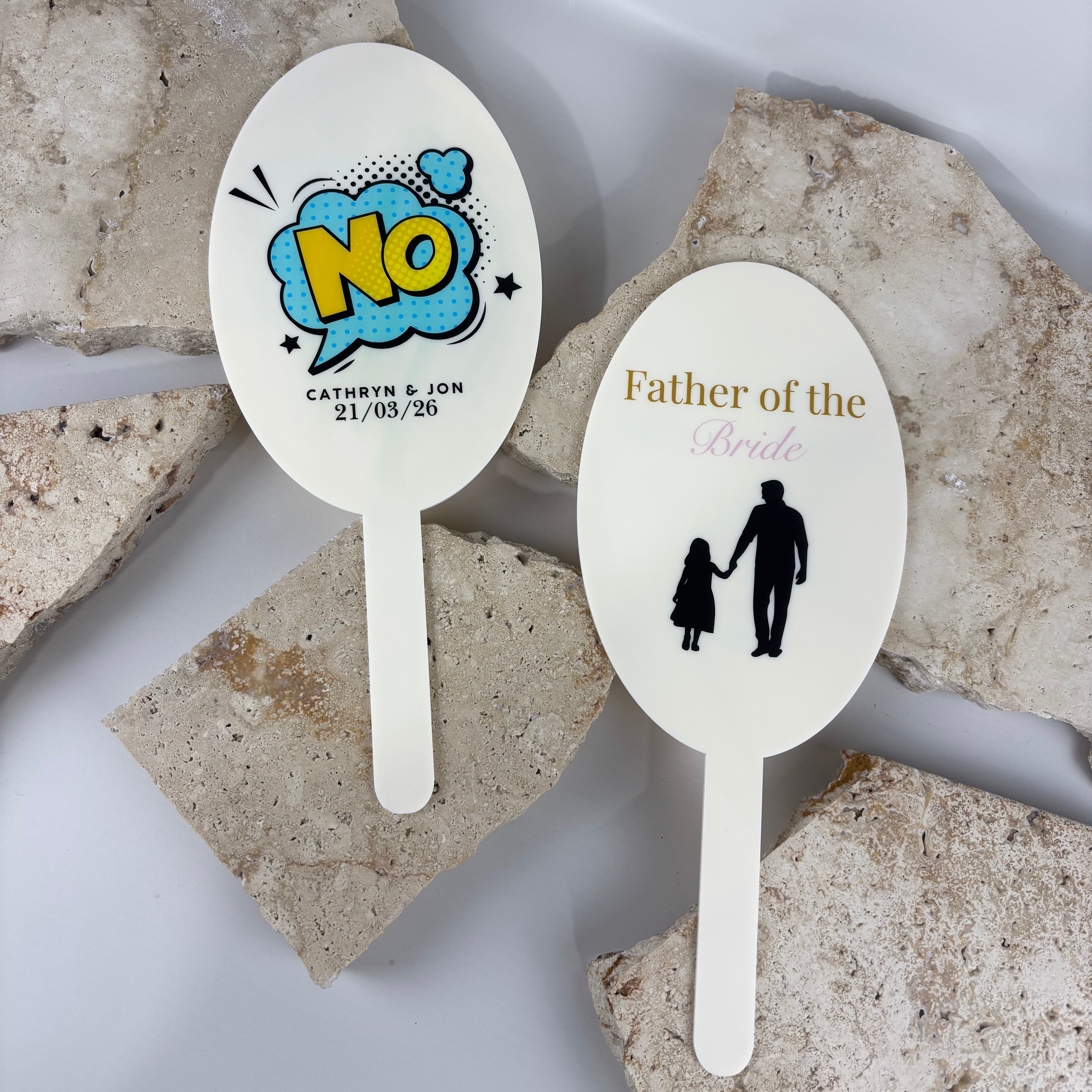 Personalised wedding paddle signs with custom text and designs including “father of the bride” for wedding reception games and photo props