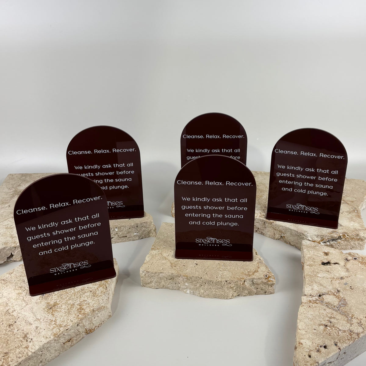 Custom acrylic arch information signs with printed business logo and text, ideal for wellness centres, spas, salons, clinics and reception areas.