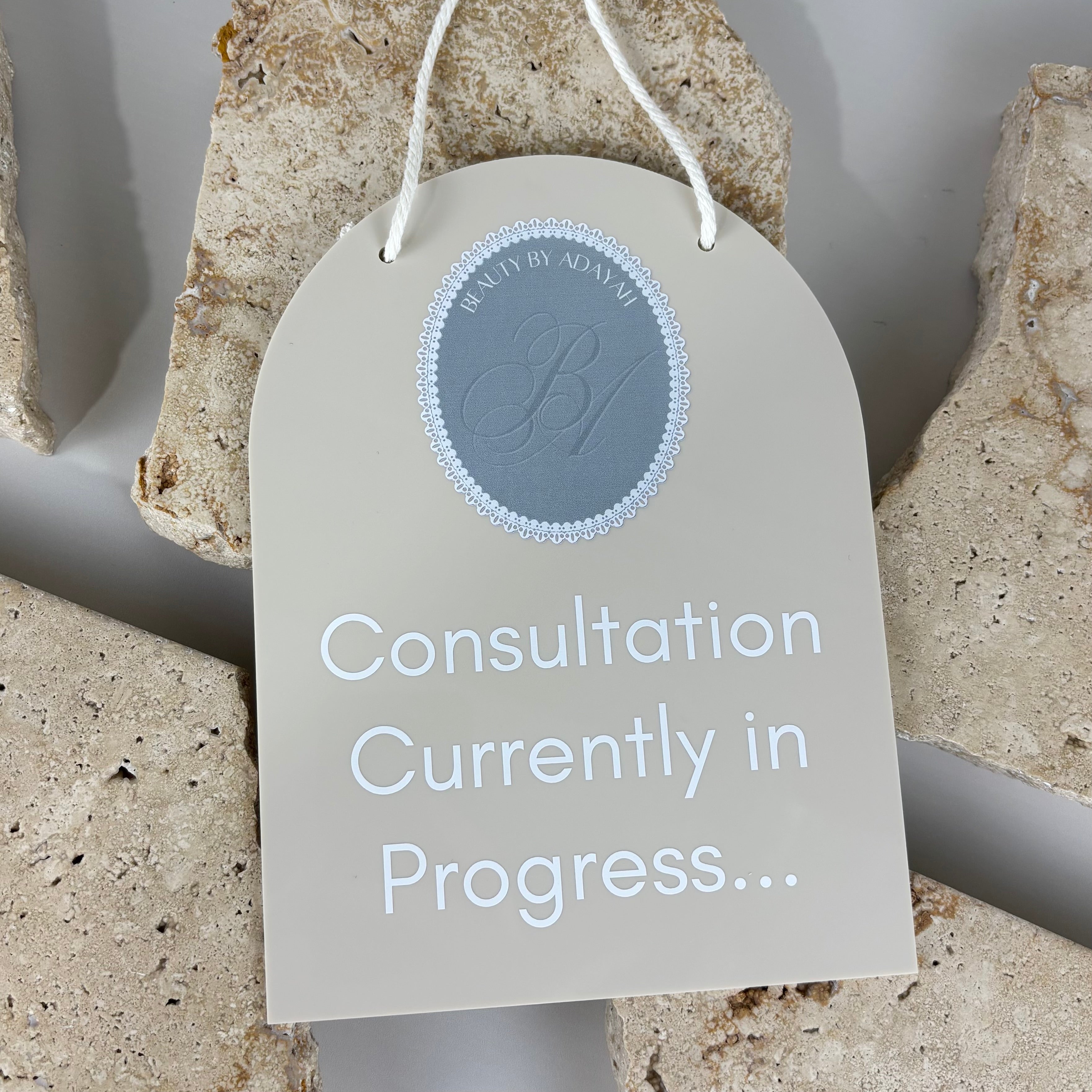 neutral beige acrylic salon door sign with rope handle displaying “consultation currently in progress,” custom clinic privacy signage for beauty rooms and treatment spaces australia