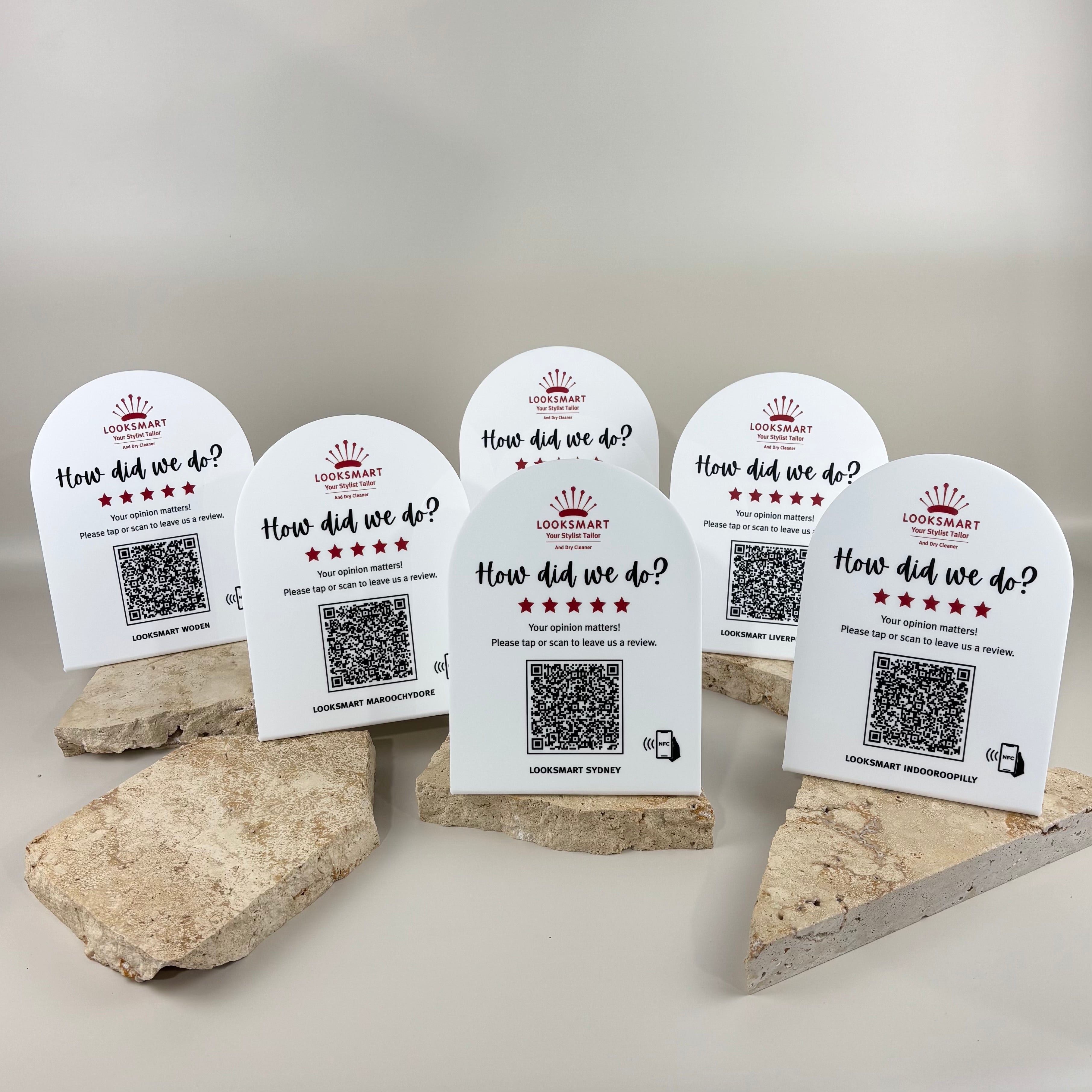 Custom white acrylic NFC Google review stands for Looksmart tailoring stores, featuring UV printed branding, QR codes and contactless tap technology to help customers quickly leave Google reviews.