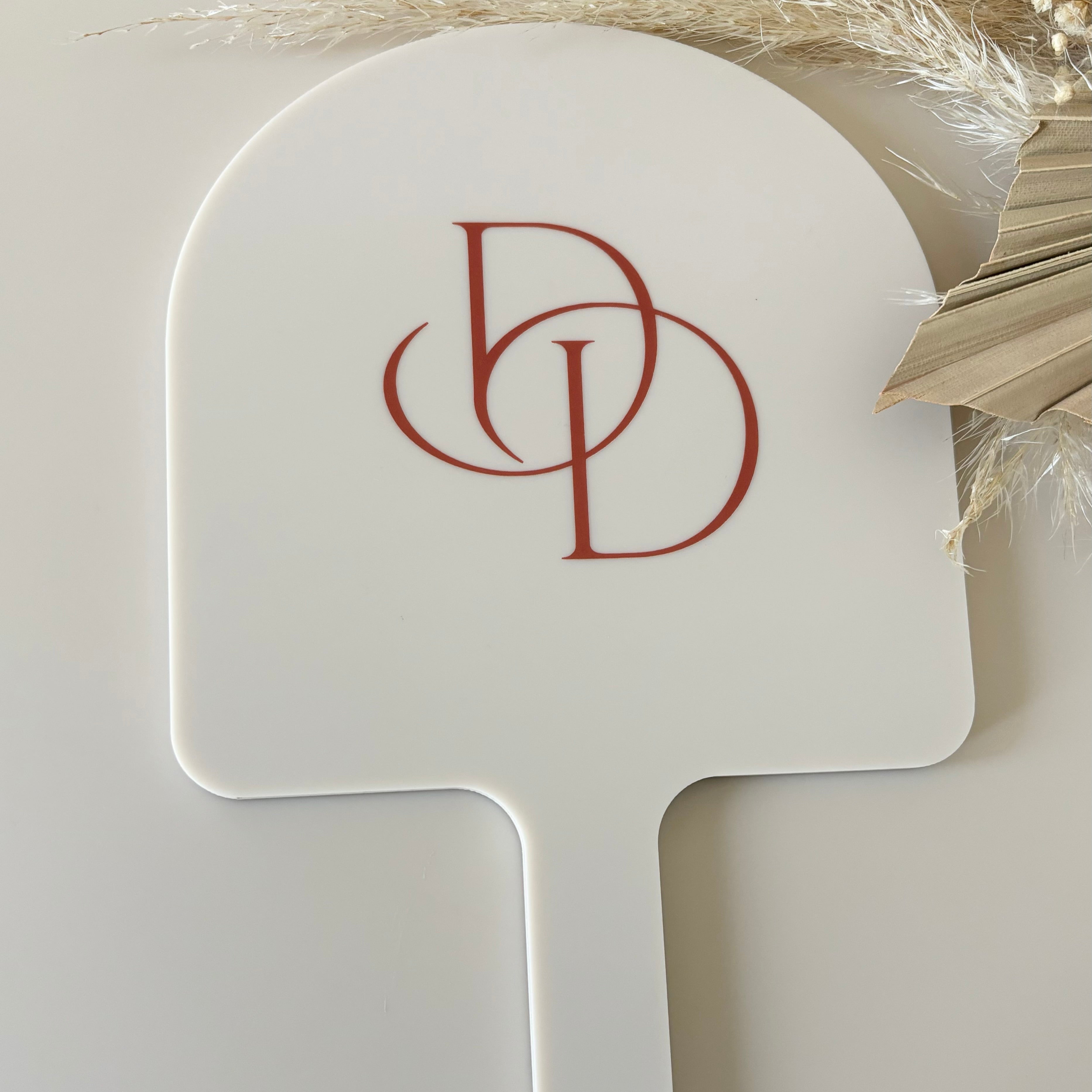 DD logo on custom arched handheld salon mirror
