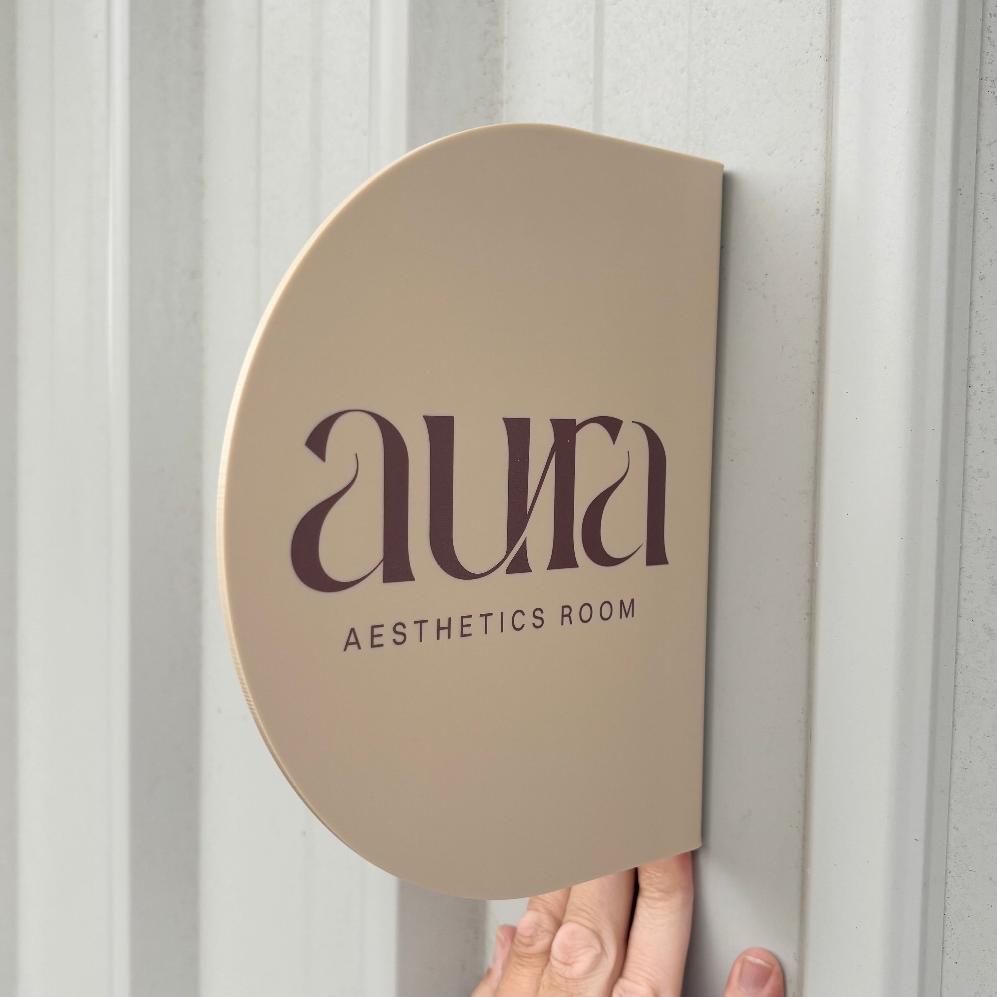 Custom nude beige acrylic aesthetics room sign with UV printed logo, contemporary wall-mounted business signage for cosmetic clinics and treatment rooms. Elegant half-round salon sign designed for beauty, skin and aesthetics professionals.
