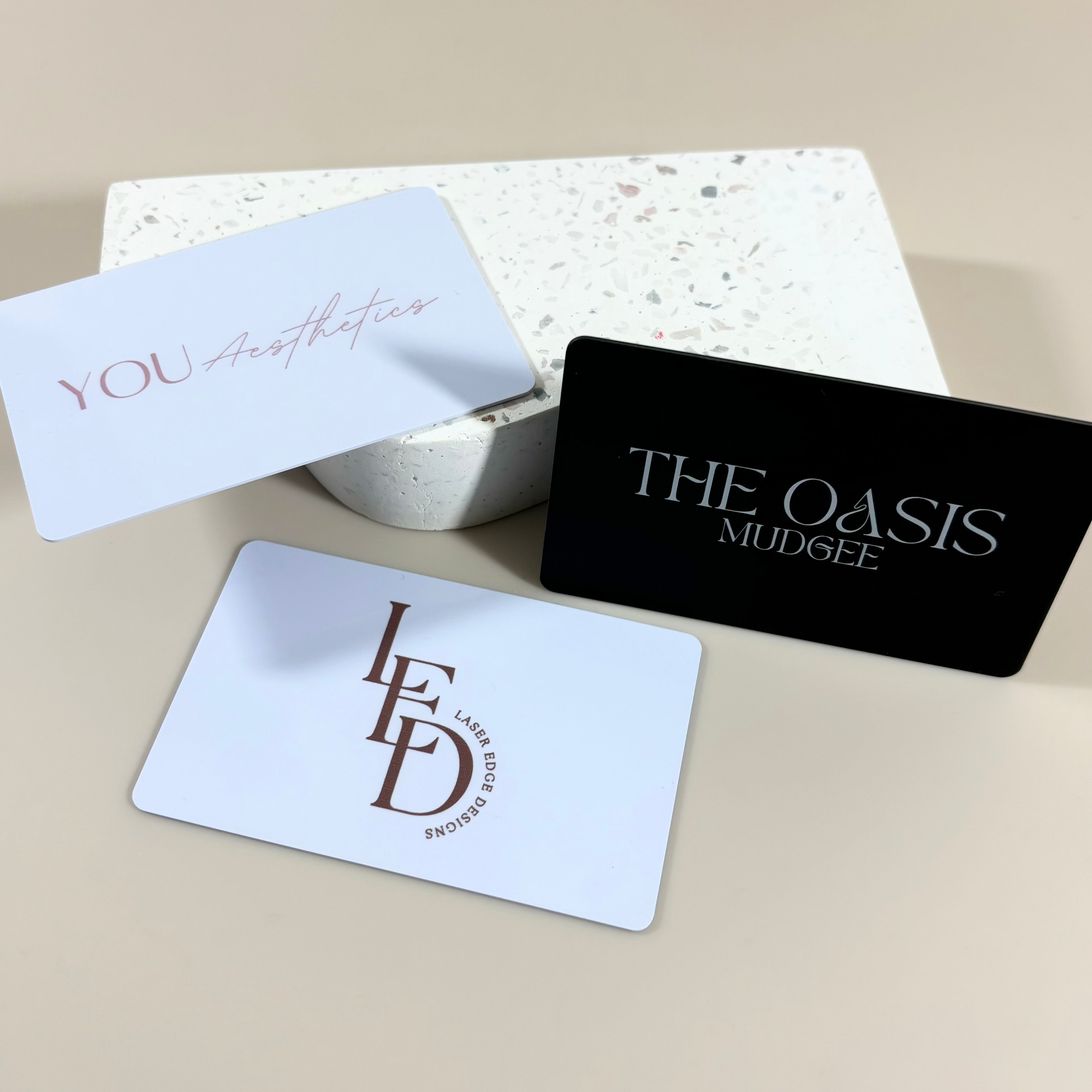 Minimal white and black NFC business cards with salon and studio logos