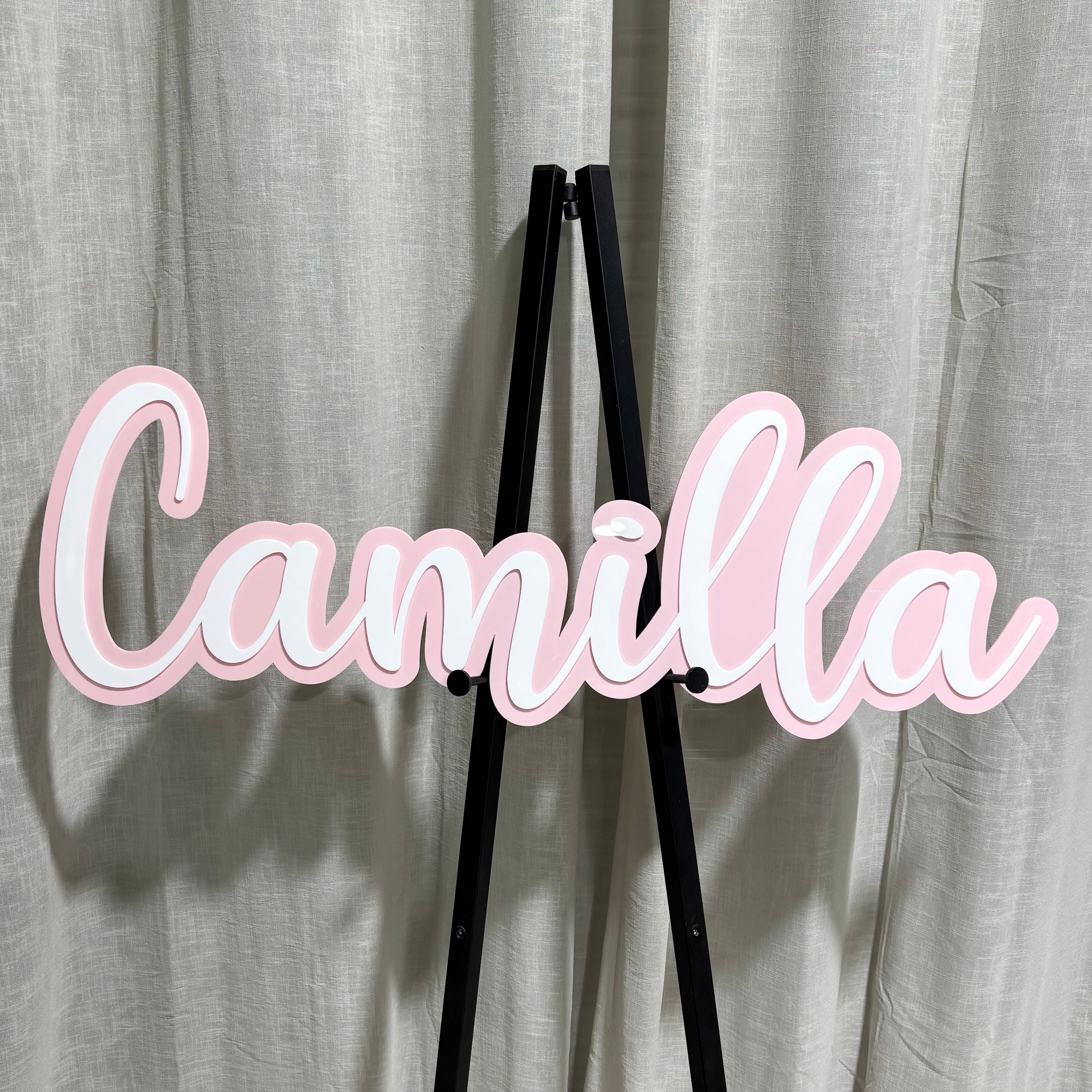 Personalised layered acrylic name plaque with soft pink and white script text, custom name signage for businesses, events or branding displays, made in Australia