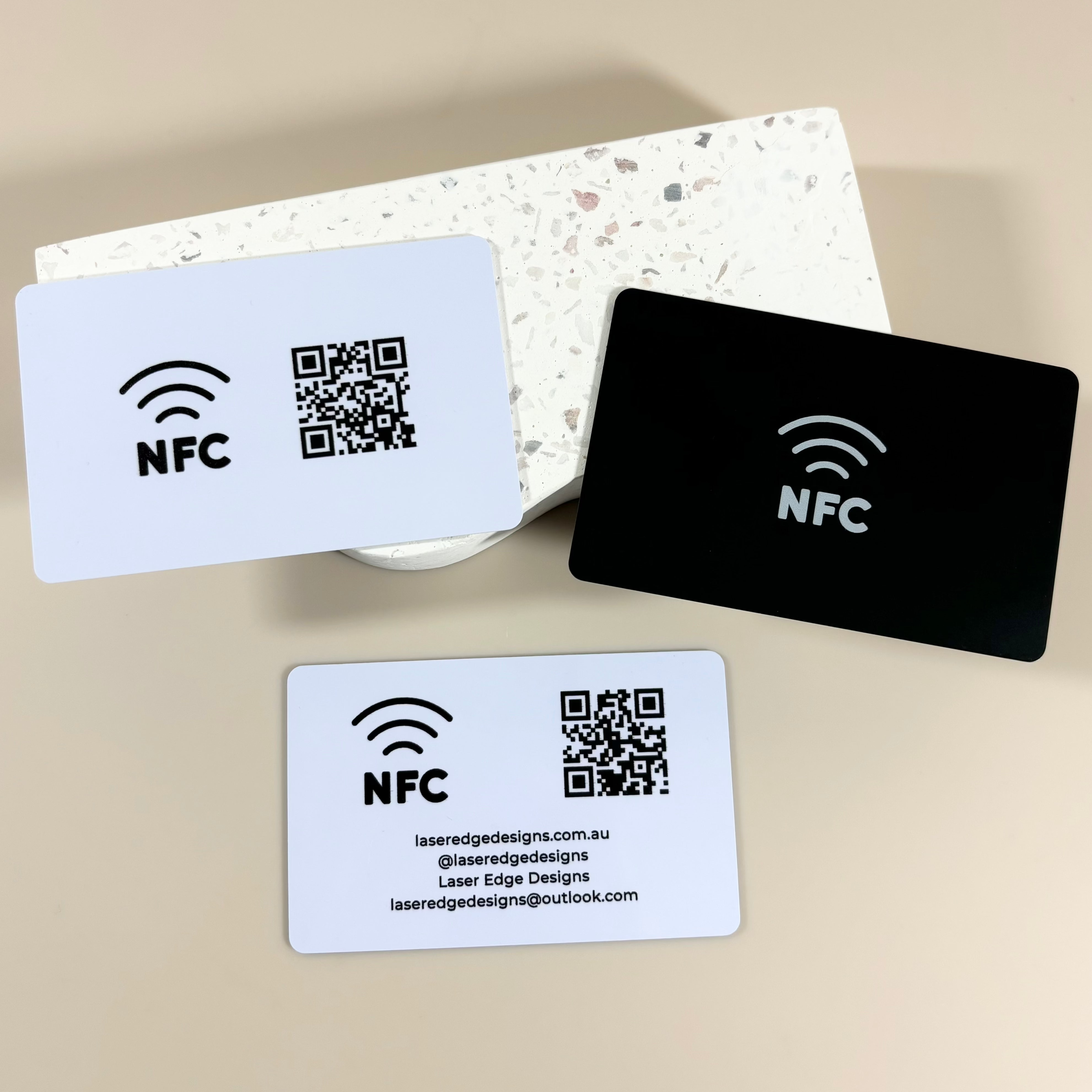 Dual-tone NFC cards with QR codes and wireless icons for digital networking
