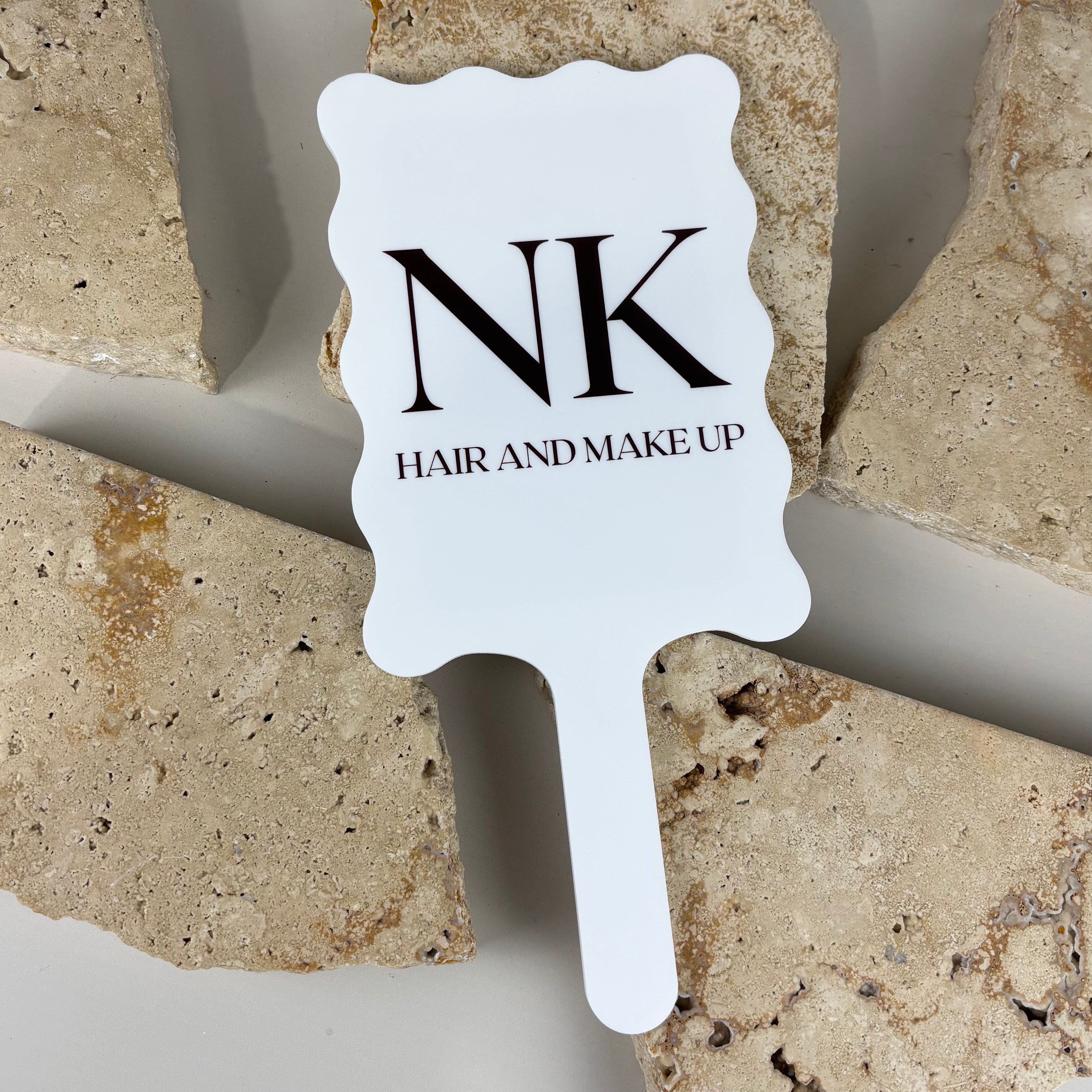 Custom white acrylic hair and makeup sign with scalloped edge and handle, featuring NK Hair and Makeup logo, UV printed salon branding sign for beauty business Australia