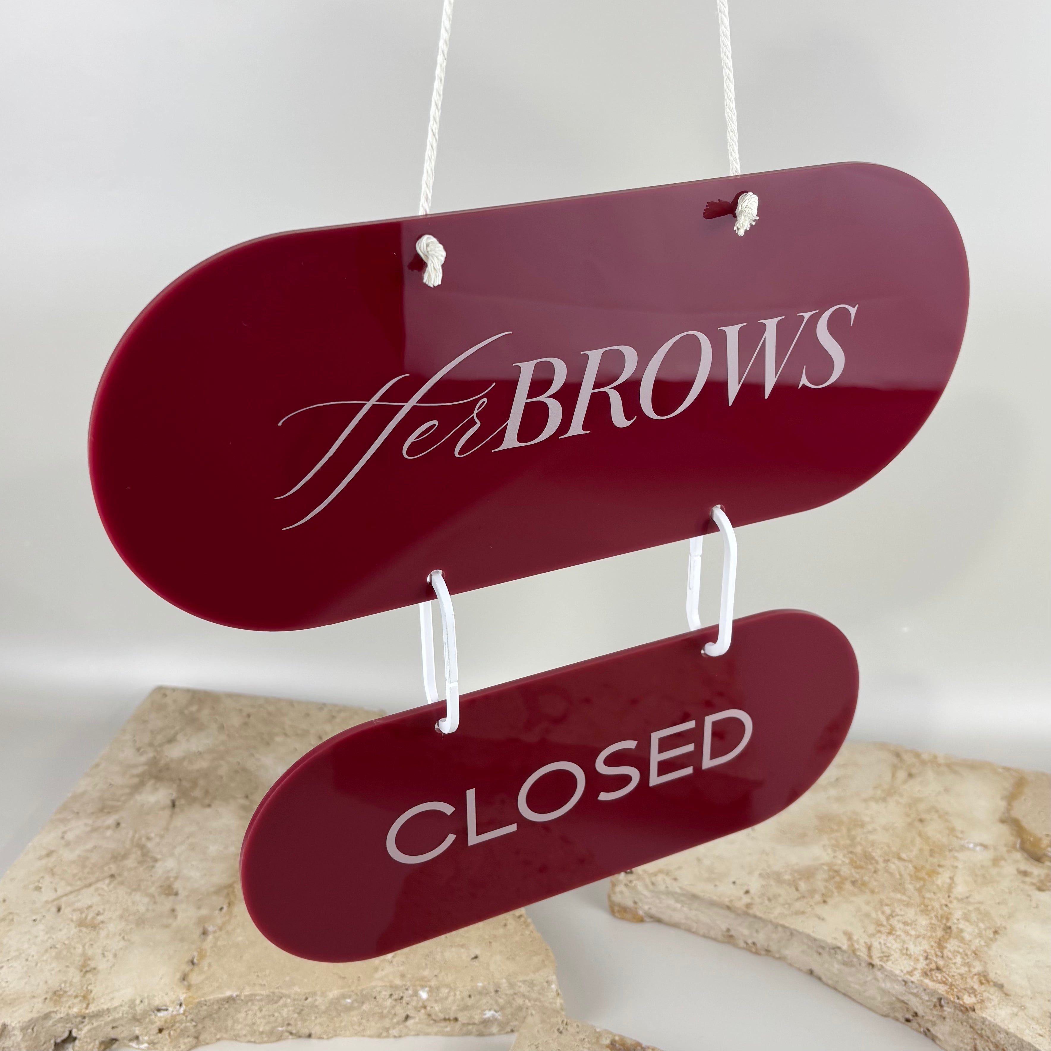 Custom burgundy acrylic closed business sign with logo, double-sided capsule hanging door sign for salon, beauty studio or shop.