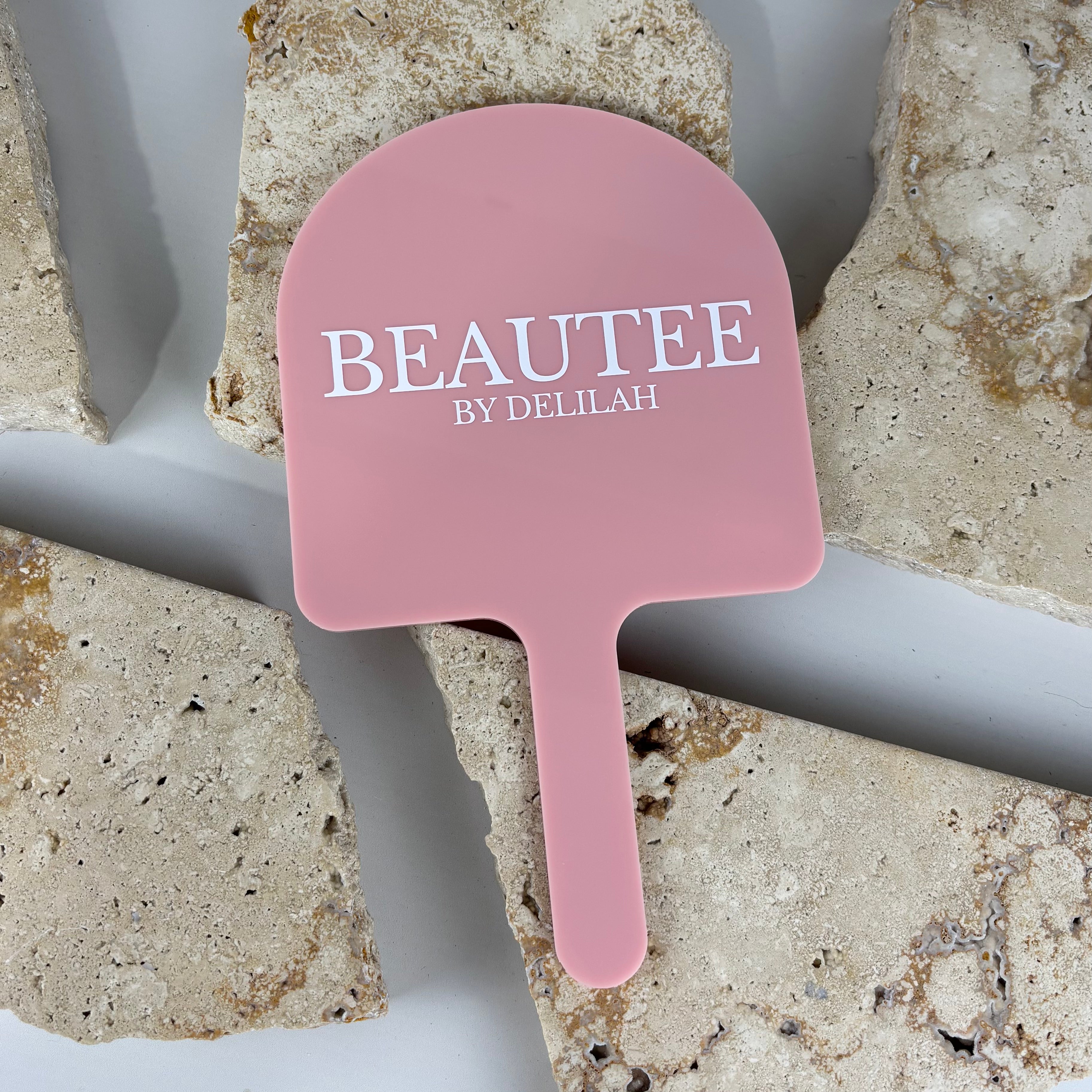 Pink acrylic branded handheld mirror with custom salon logo, lightweight professional hand mirror for beauty salons, lash and makeup artists, ideal for client reveals, consultations and after treatment checks.