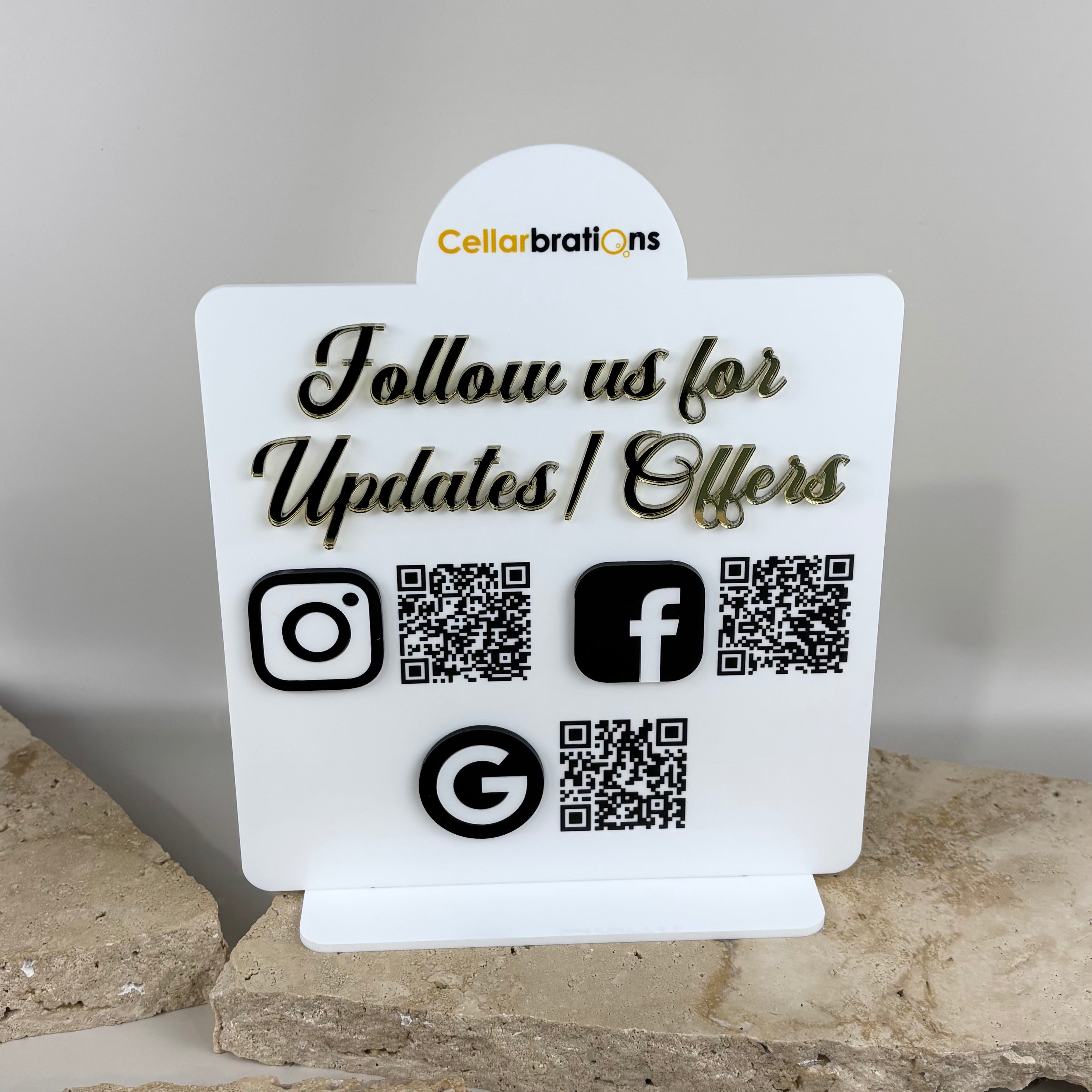 Custom acrylic QR code business sign with 3D gold mirror lettering reading “Follow us for updates and offers,” featuring Instagram, Facebook and Google icons with scannable QR codes, modern white display stand for retail counters and small business branding Australia