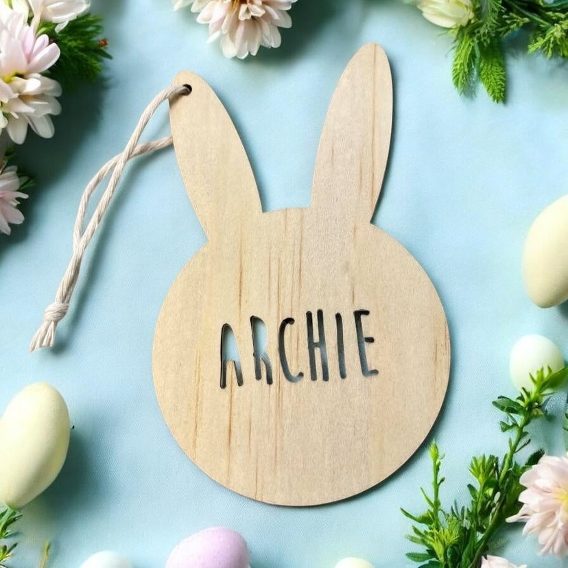 Personalised wooden Easter bunny name tag engraved with child’s name, wooden Easter basket tag on pastel blue background
