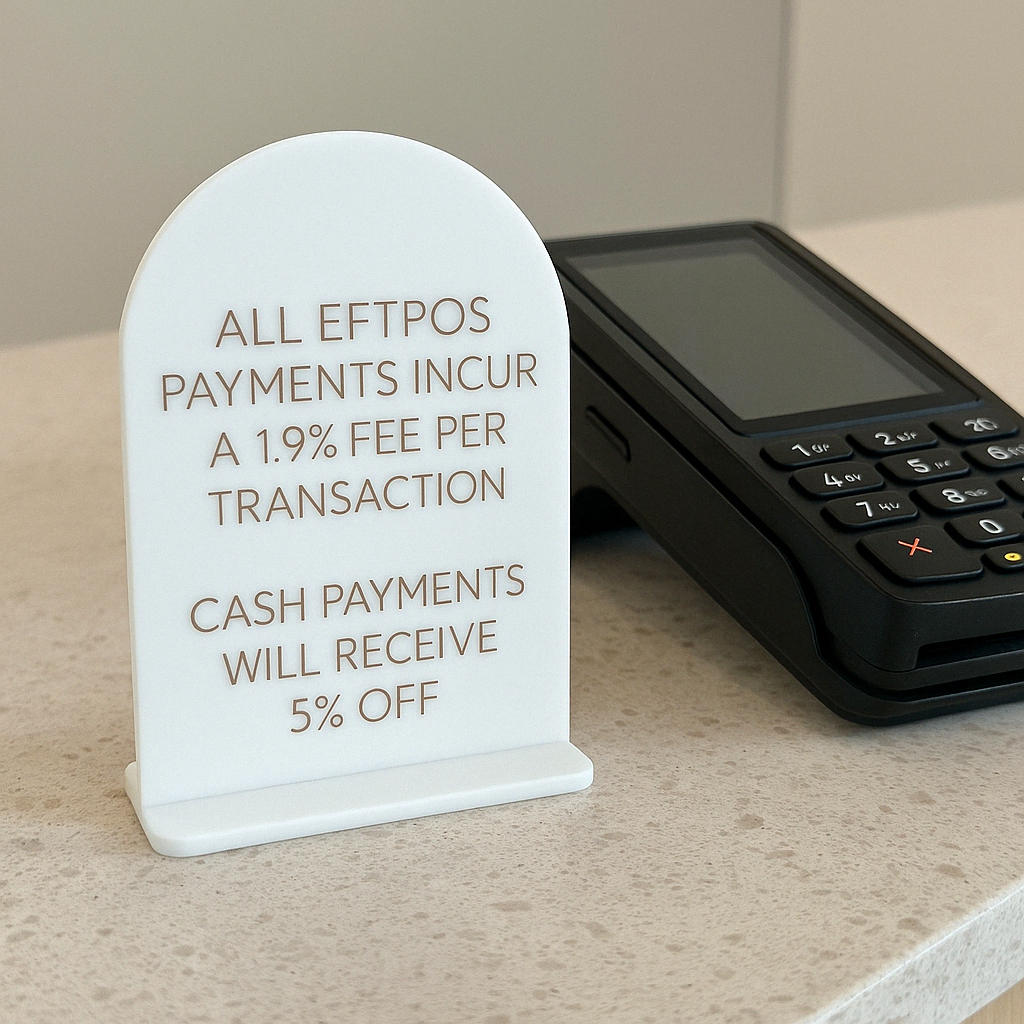 White mini info sign for eftpos surcharge details on counter