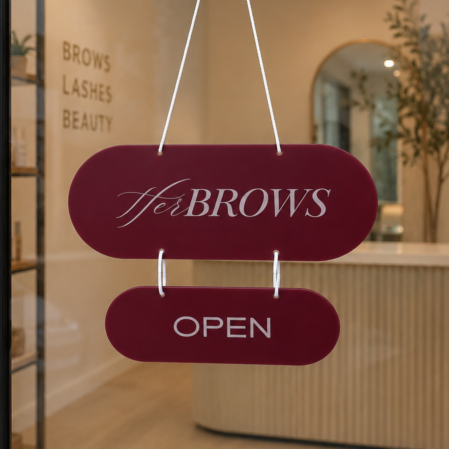 Custom burgundy acrylic open closed business sign with logo hanging on a beauty salon door, double-sided capsule shopfront sign.