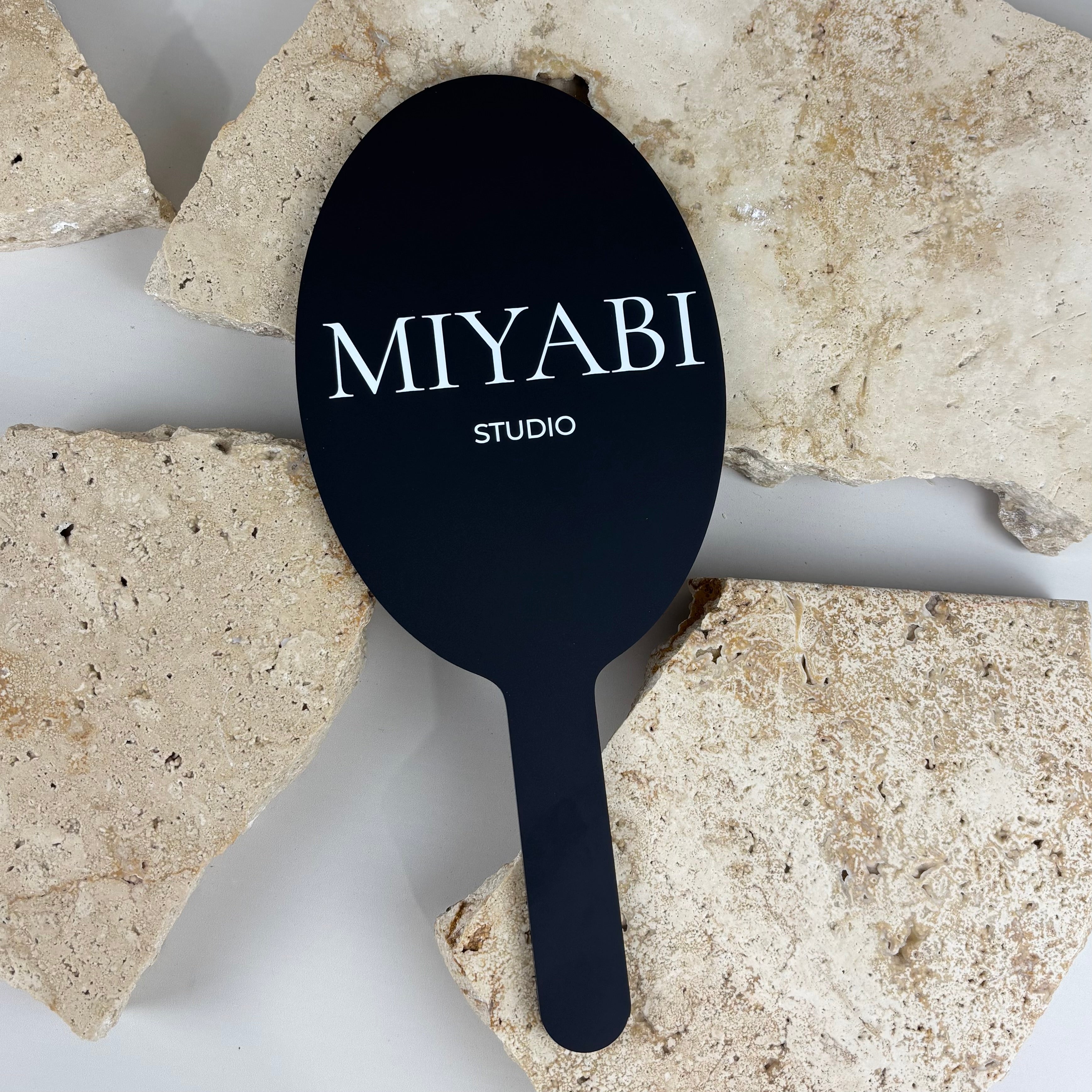 Custom acrylic handheld mirror with logo MIYABI Studio, branded salon mirror for hairdressers and beauty professionals, black acrylic mirror with white UV printed text, personalised business mirror Australia, aesthetic salon accessory for client use and branding, lightweight handheld mirror for hair and beauty studios