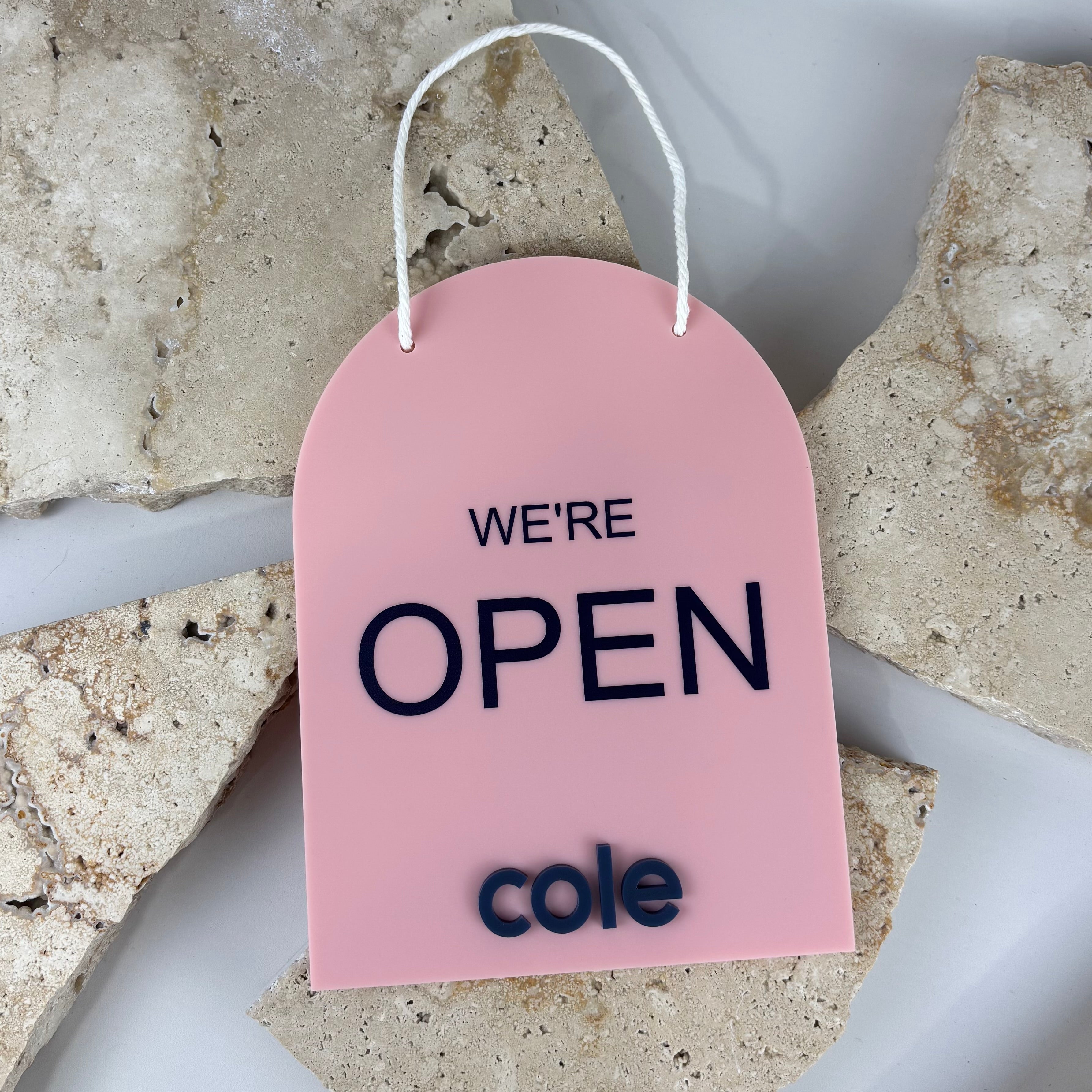 custom acrylic open sign door hanger australia, blush pink business open sign with raised black lettering, personalised shop open sign with rope hanger, salon retail storefront signage