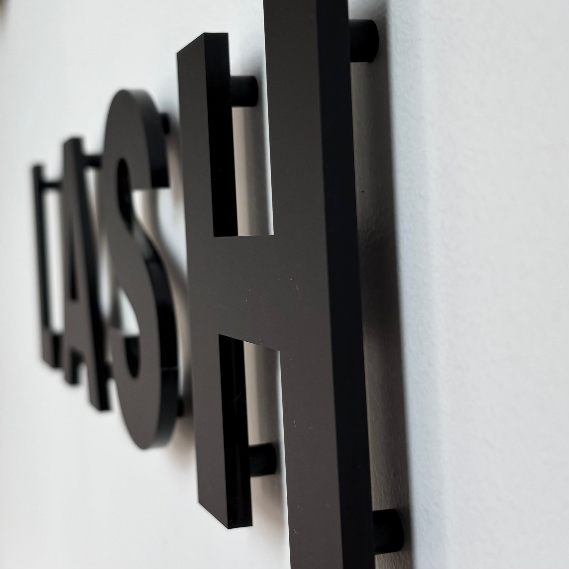 3D floating acrylic lettering sign side view showing spacer mounted raised letters premium wall signage for salon branding