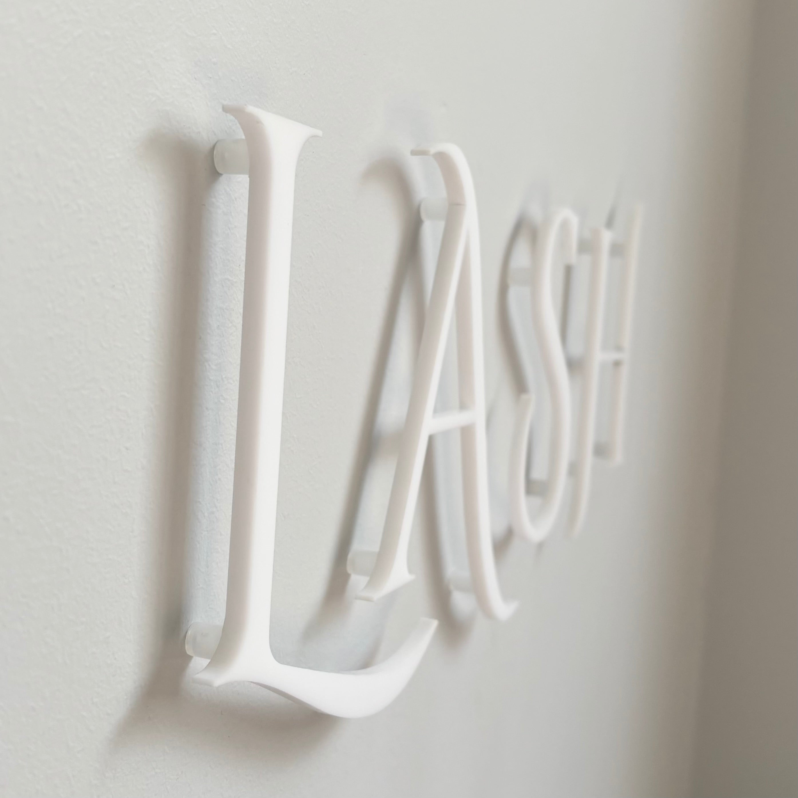 raised white acrylic lettering sign close up 3D floating letters with shadow effect premium interior wall signage