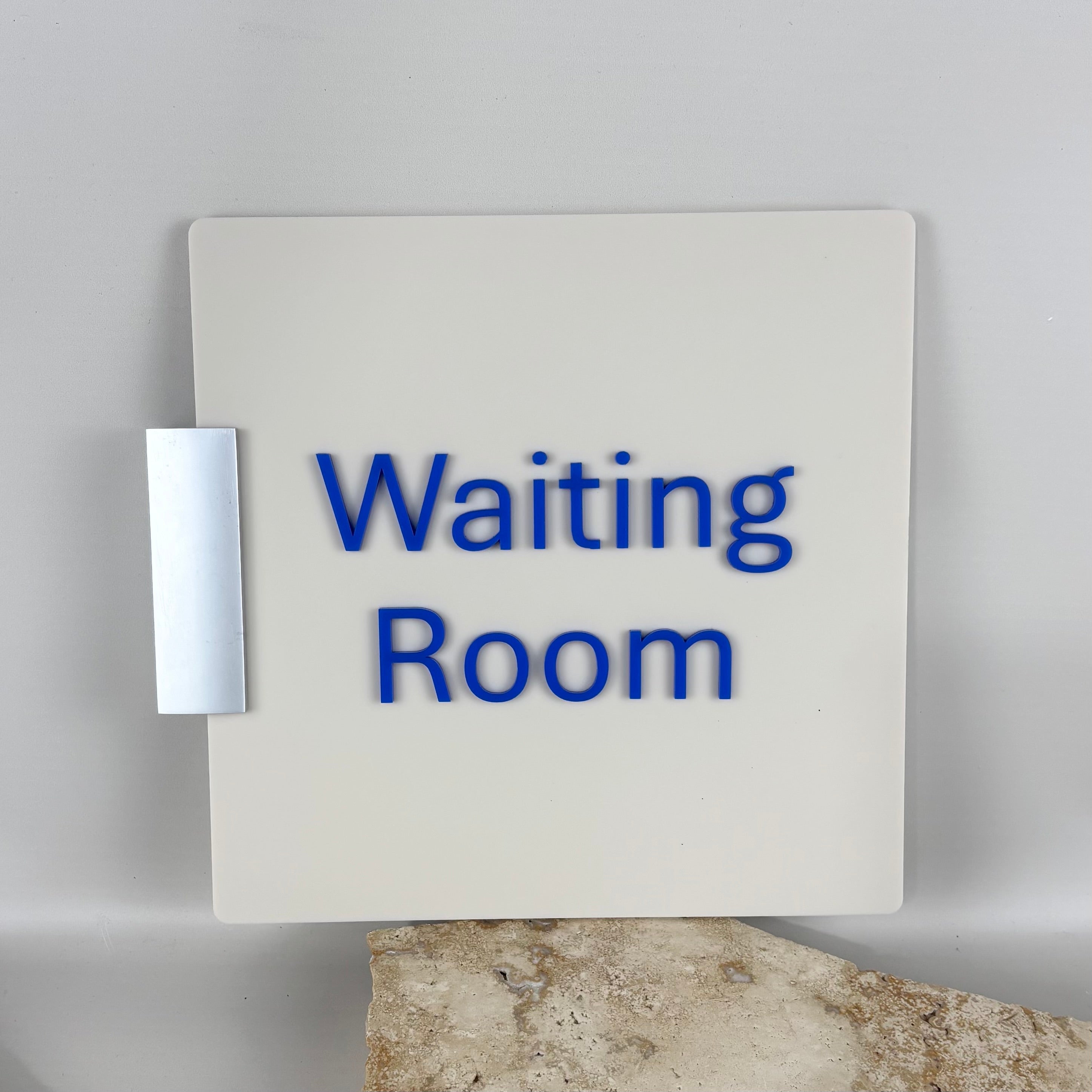 3D acrylic waiting room sign with raised blue lettering on white panel, modern medical clinic wall signage, professional reception signage Australia, custom acrylic door sign for healthcare and office spaces