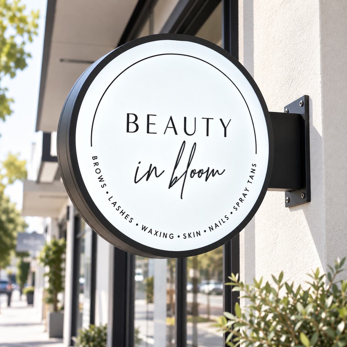 Custom round LED blade sign for Beauty in Bloom salon, mounted outside a modern storefront with black frame and illuminated business logo.