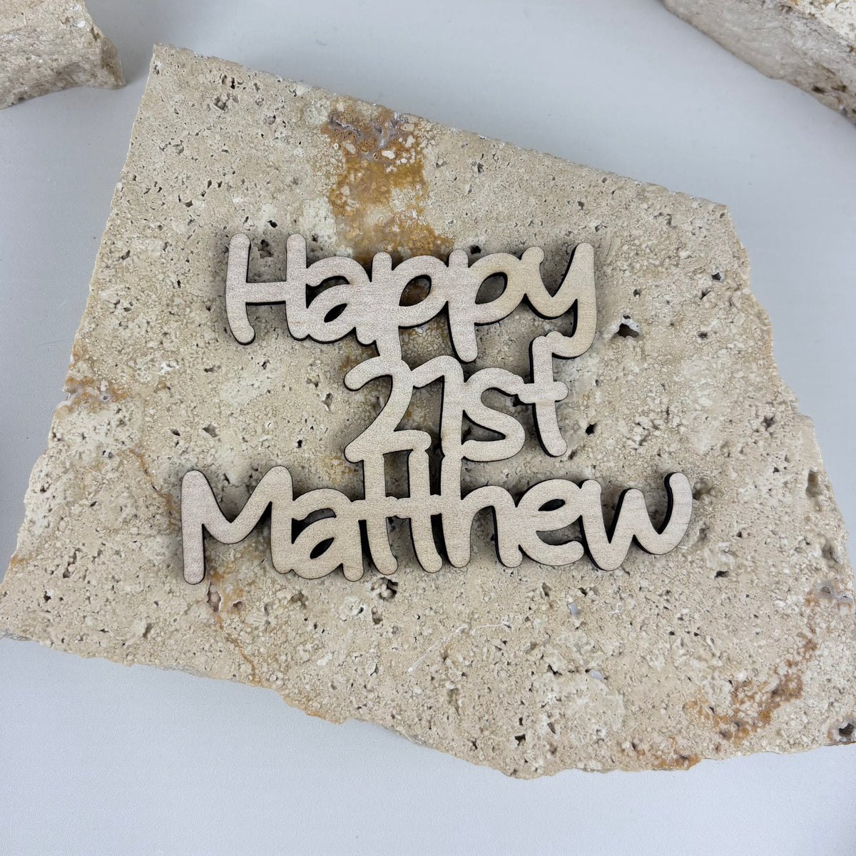 Personalised timber cake froppers with custom names and ages for birthday cake decorations.