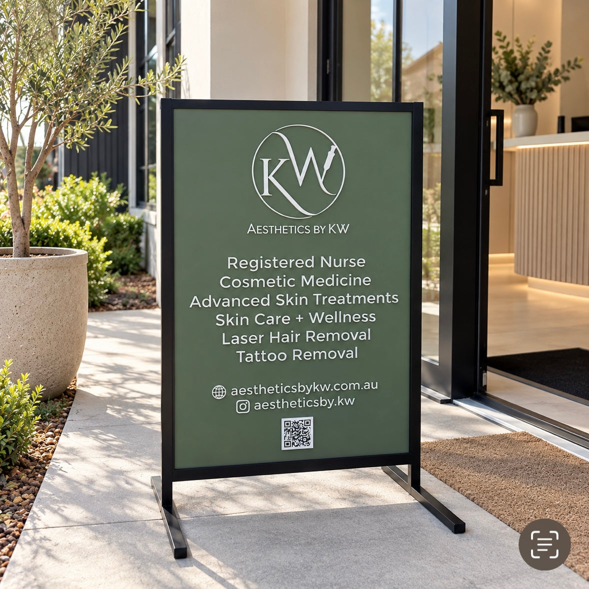 Custom outdoor T-frame business sign for aesthetics clinic with sage green panel, white lettering, service list and QR code at modern clinic entrance.