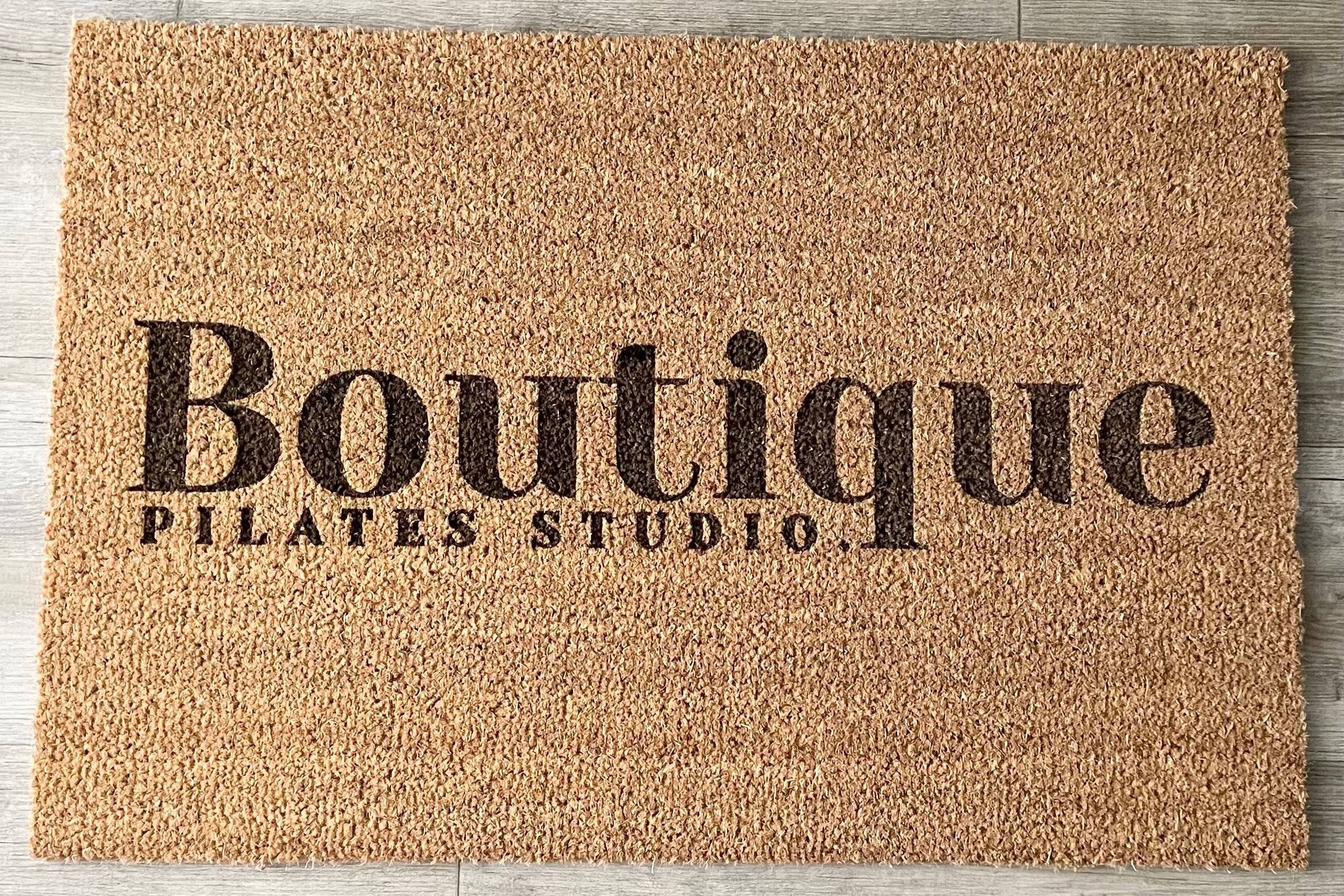 Boutique logo printed on a custom door mat for studios