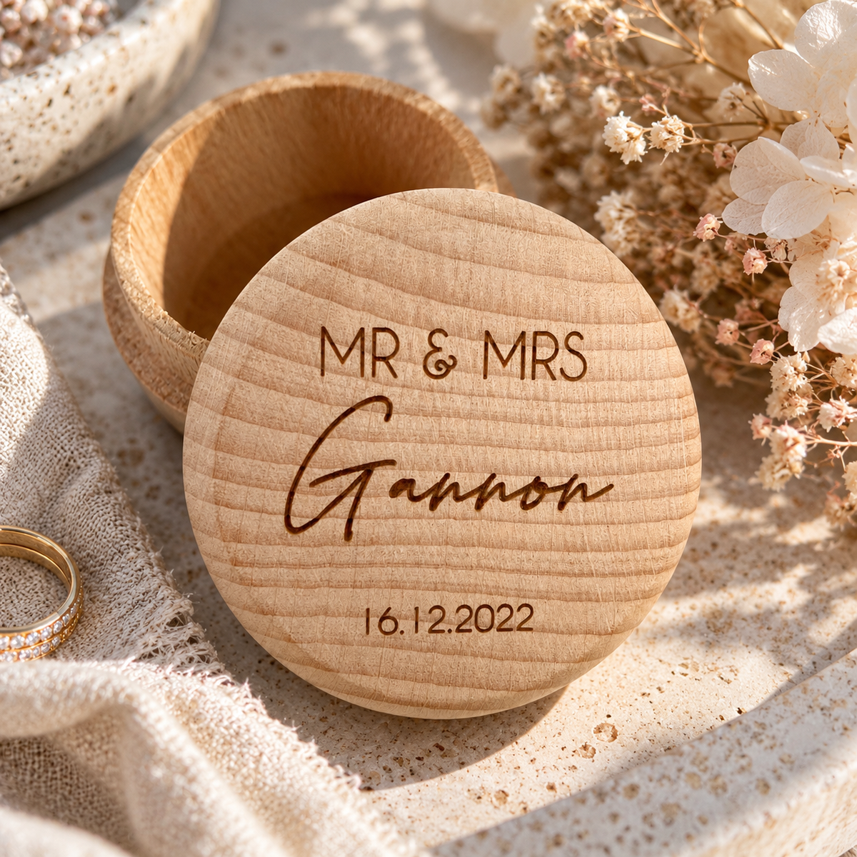 Personalised engraved wooden wedding ring box with custom Mr & Mrs names and wedding date, styled with dried flowers and wedding rings.
