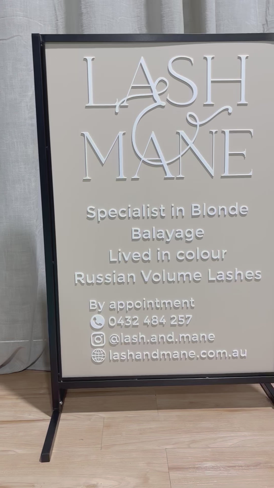 Custom T frame video advertising stand with white acrylic lettering